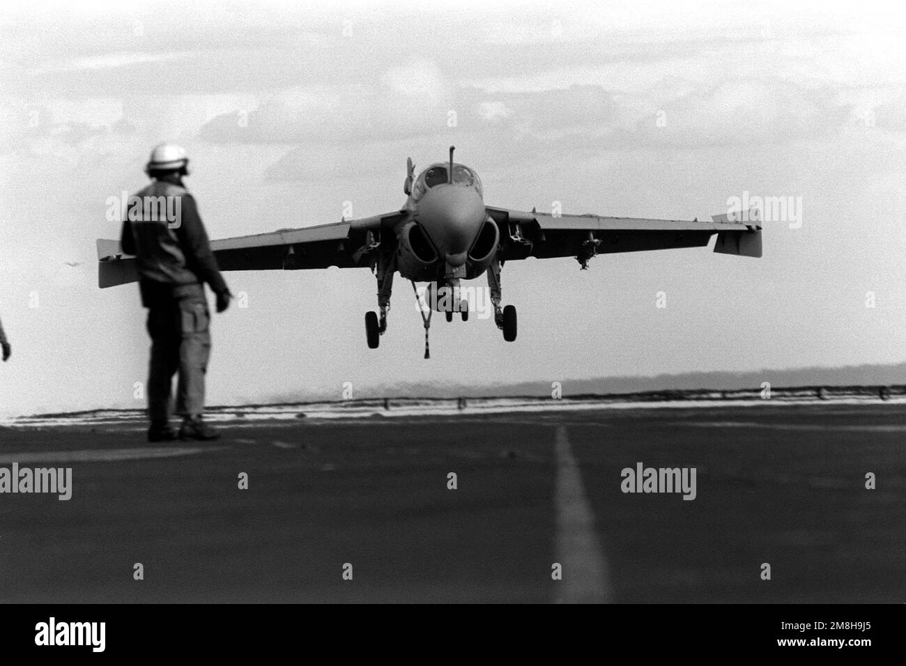 A flight deck crewman watches as an Attack Squadron 75 (VA-75) A-6E Intruder aircraft lands on the aircraft carrier USS JOHN F. KENNEDY (CV-67). Country: Adriatic Sea Stock Photo