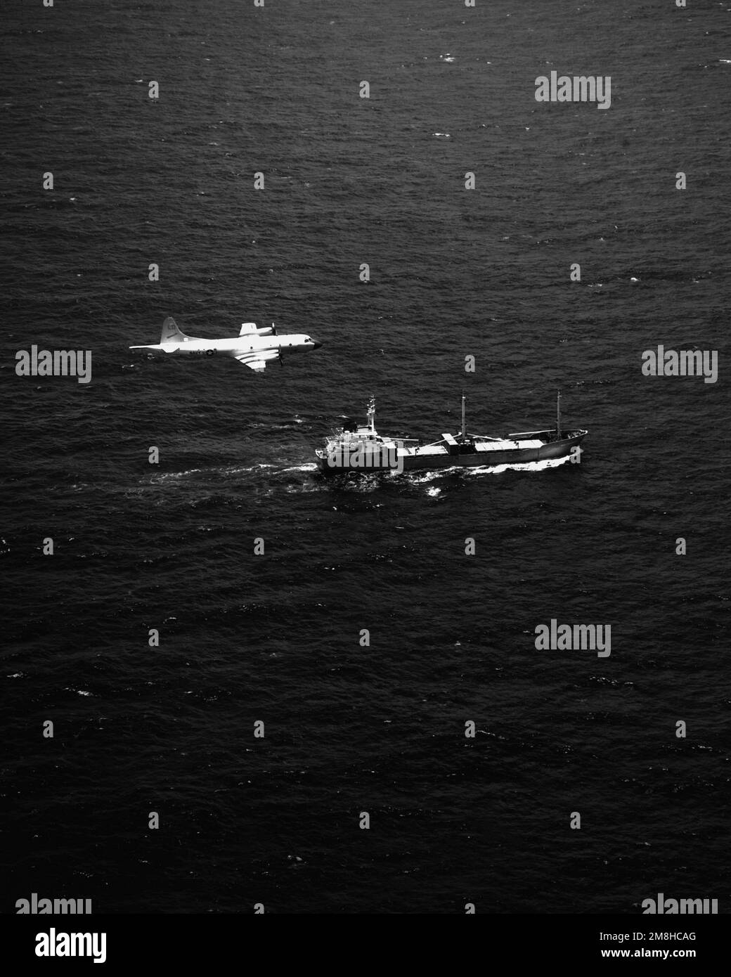 A P-3C Orion aircraft of Patrol Squadron 10 (VP-10) flies over the SS Sea Chariot, a merchant vessel suspected of drug-trafficking activities. Discovered by the patrol squadron's Combat Aircrew Two in the waters southwest of Costa Rica, the ship was found to be carrying II,233 pounds of cocaine when boarded by U.S. Coast Guard personnel. Country: Pacific Ocean (POC) Stock Photo