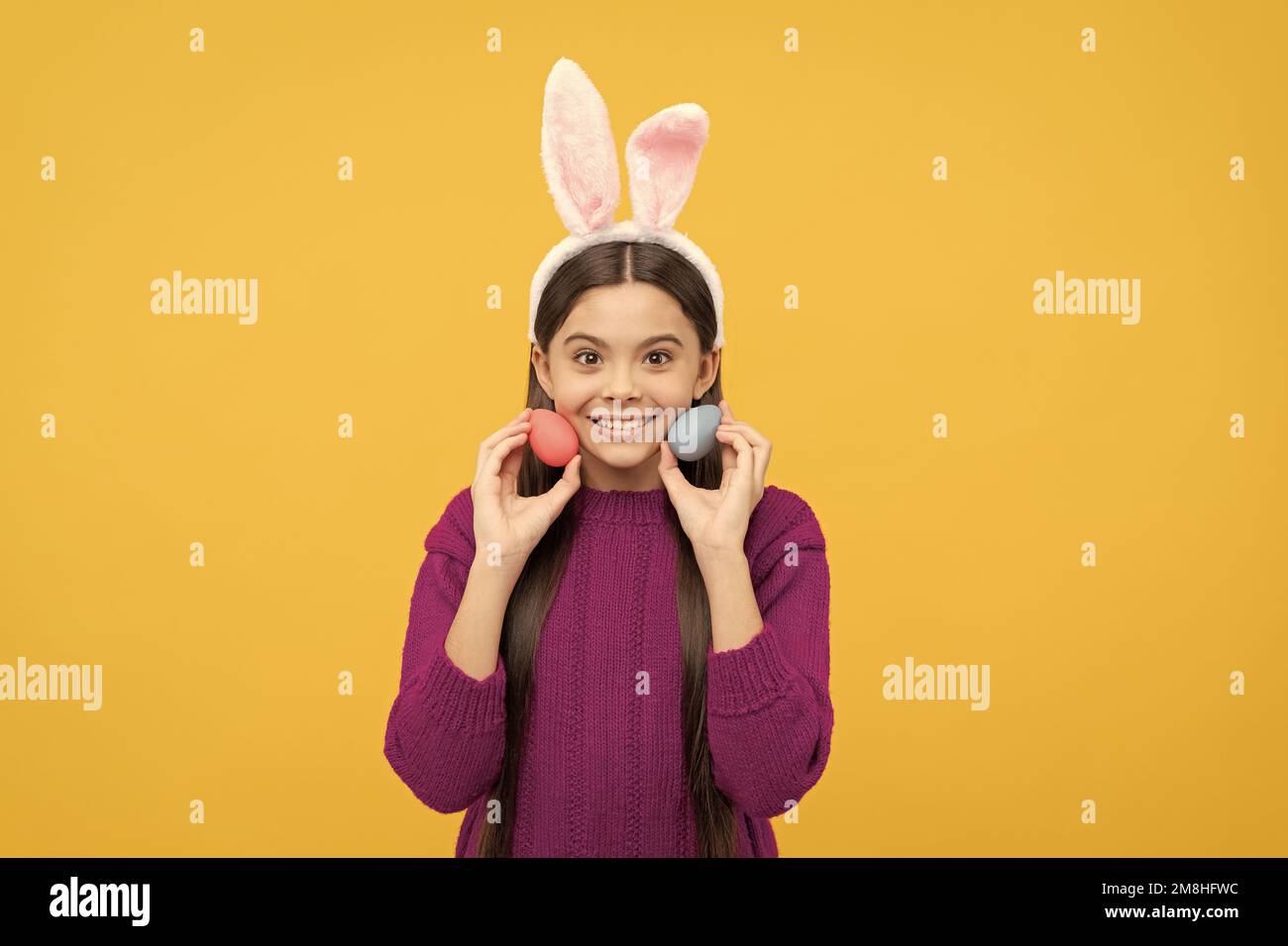 looking for eggs. funny child in hare ears. teenager girl wear rabbit ...
