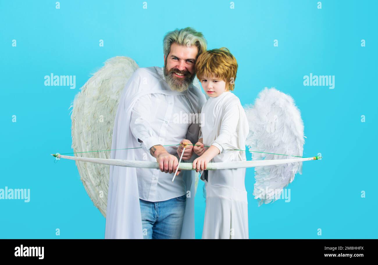 Valentines day. Arrows of love. Little angel child boy and father shooting with bow and arrow. Stock Photo