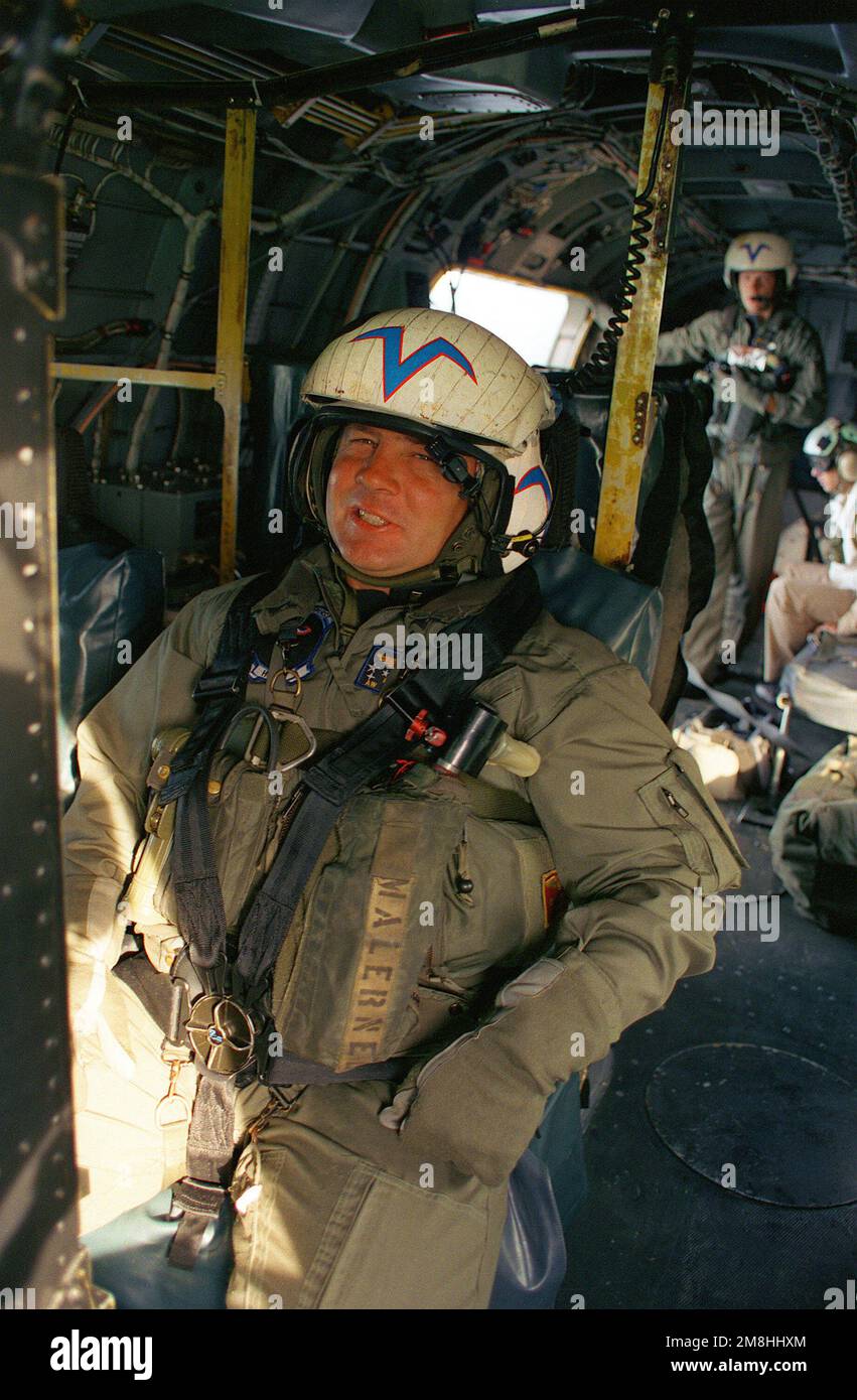 A SH-3 Sea King helicopter aircrewman relaxes in his seat during exercise BALTOPS '93. Subject Operation/Series: BALTOPS '93 Country: Baltic Sea Stock Photo