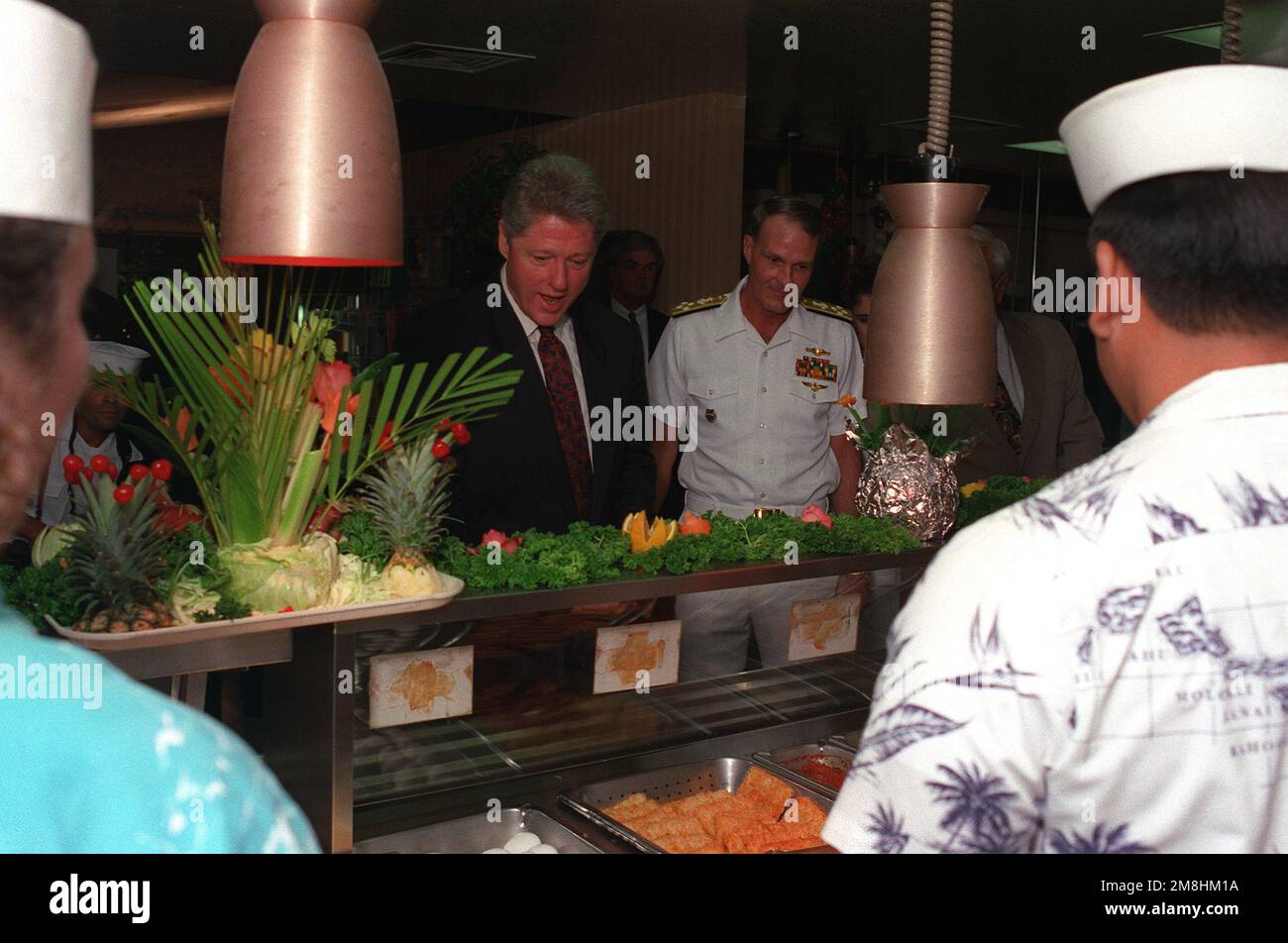 President William Jefferson Clinton and Adm. Charles R. Larson, commander-in-chief, U.S. Pacific Command, look at breakfast selections as they stand in the serving line at the enlisted galley during Clinton's tour of area military installations. Base: Naval Station, Pearl Harbor State: Hawaii (HI) Country: United States Of America (USA) Stock Photo