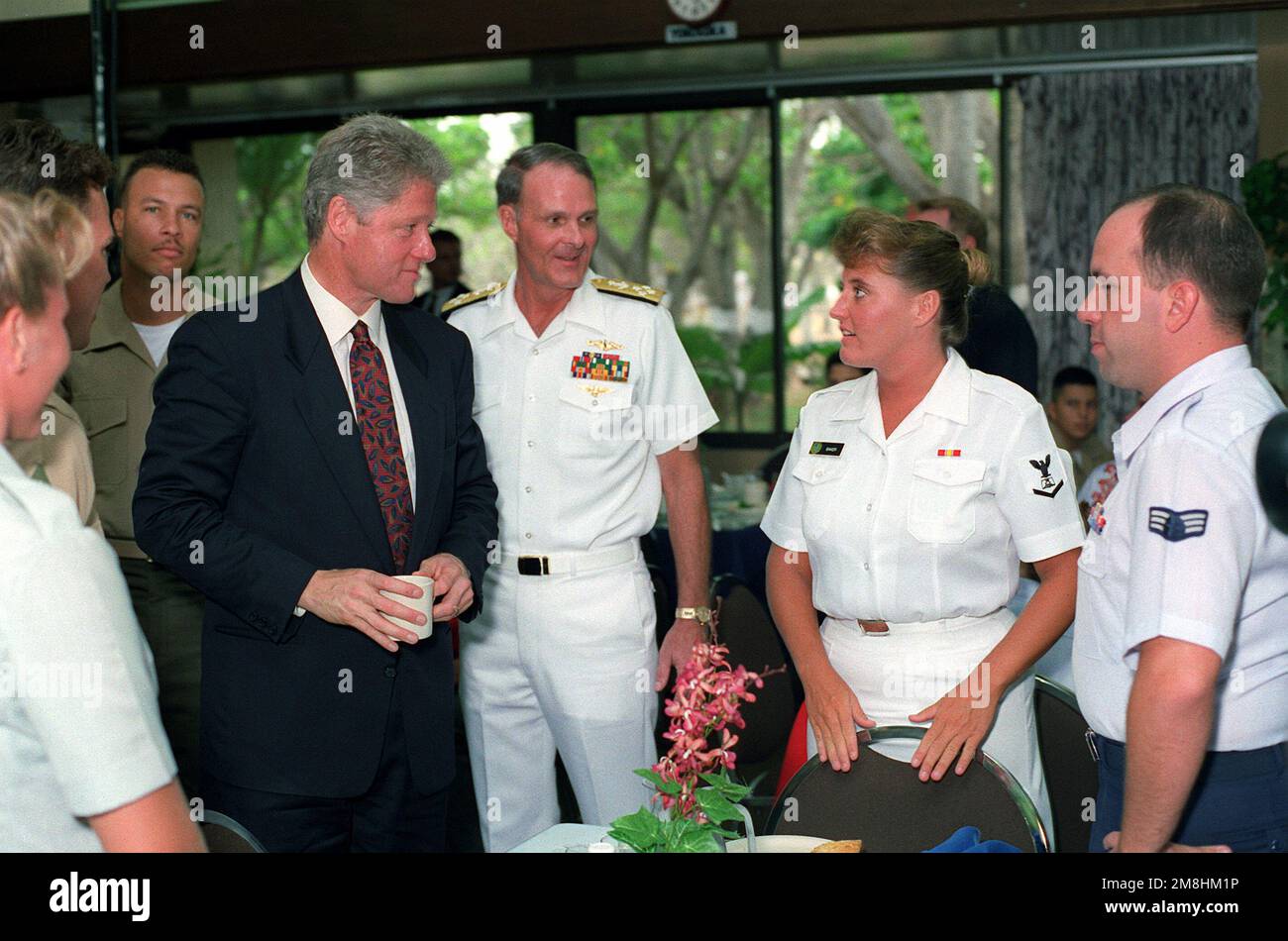 President William Jefferson Clinton and Adm. Charles R. Larson, commander-in-chief, Pacific Fleet, greet enlisted personnel during breakfast at the enlisted galley. The two are at Pearl Harbor as part of a tour of area military installations. Base: Naval Station, Pearl Harbor State: Hawaii (HI) Country: United States Of America (USA) Stock Photo
