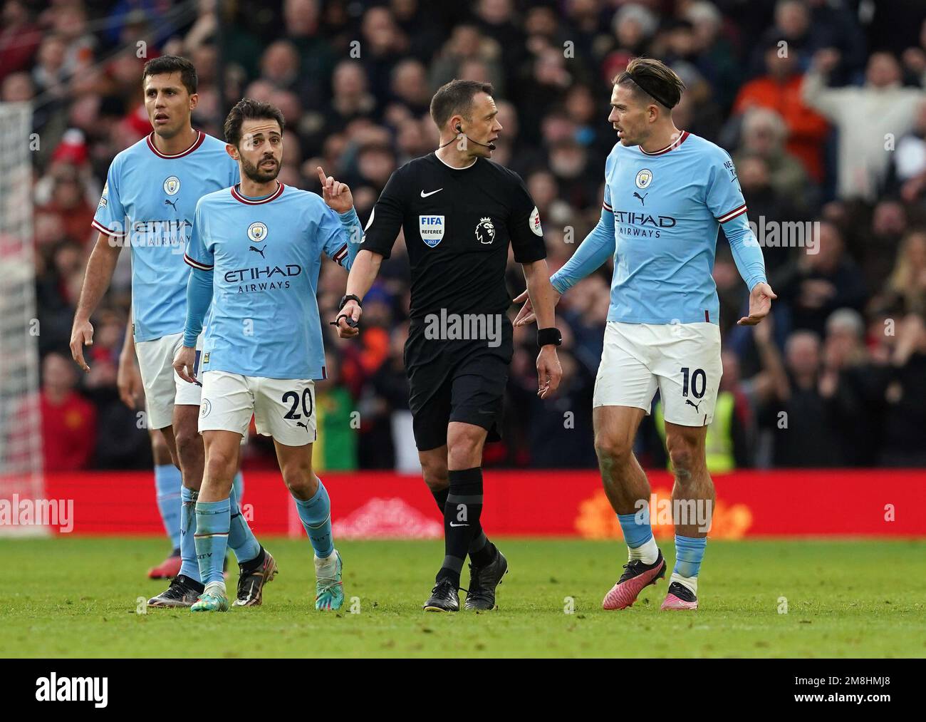 Manchester City players Jack Grealish and Bernardo Silva appeal to referee Stuart Attwell after he awarded Manchester United's first goal, scored by Bruno Fernandes during the Premier League match at Old Trafford, Manchester. Picture date: Saturday January 14, 2023. Stock Photo