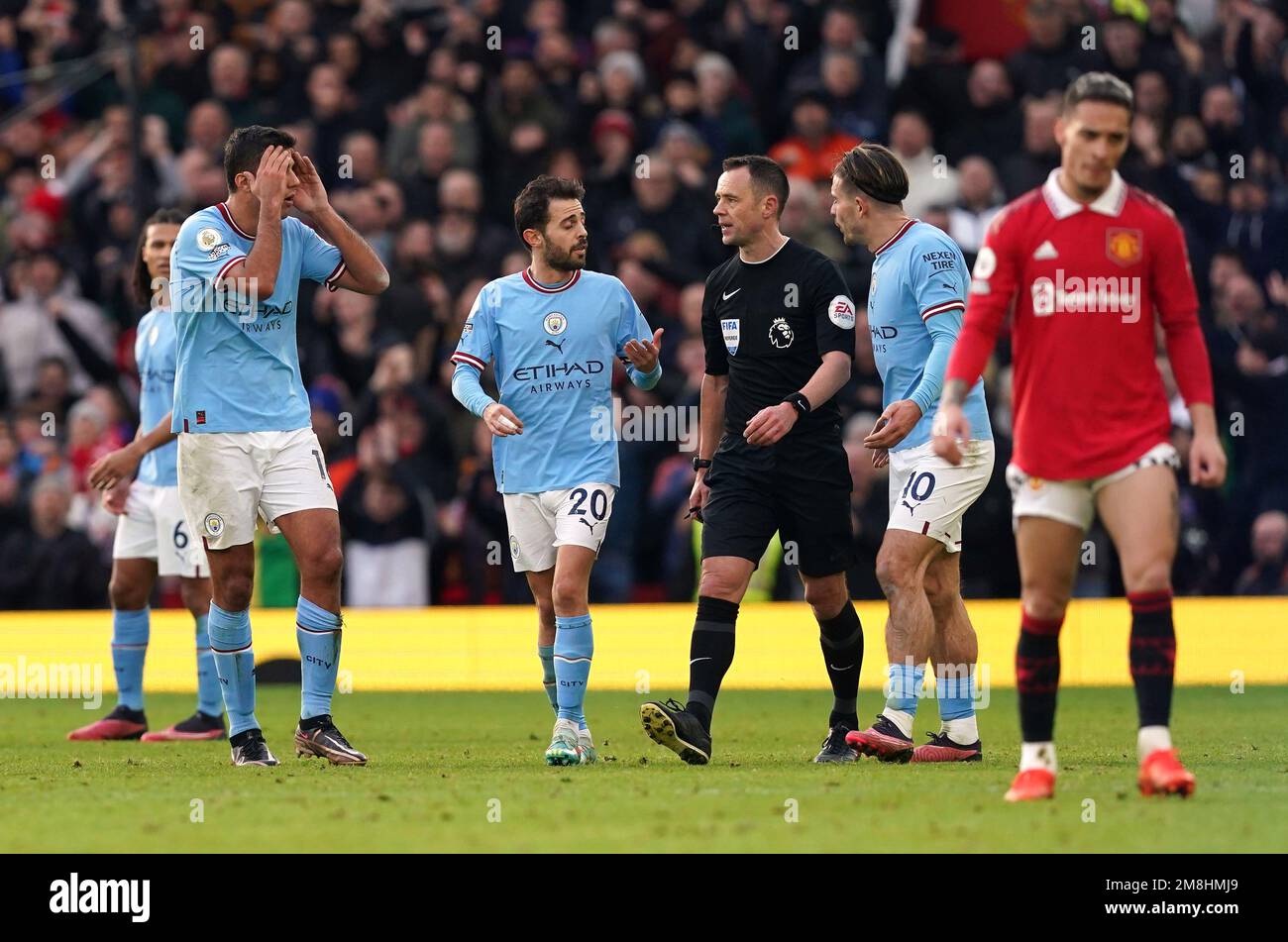 Manchester City players Jack Grealish and Bernardo Silva appeal to referee Stuart Attwell after he awarded Manchester United's first goal, scored by Bruno Fernandes during the Premier League match at Old Trafford, Manchester. Picture date: Saturday January 14, 2023. Stock Photo