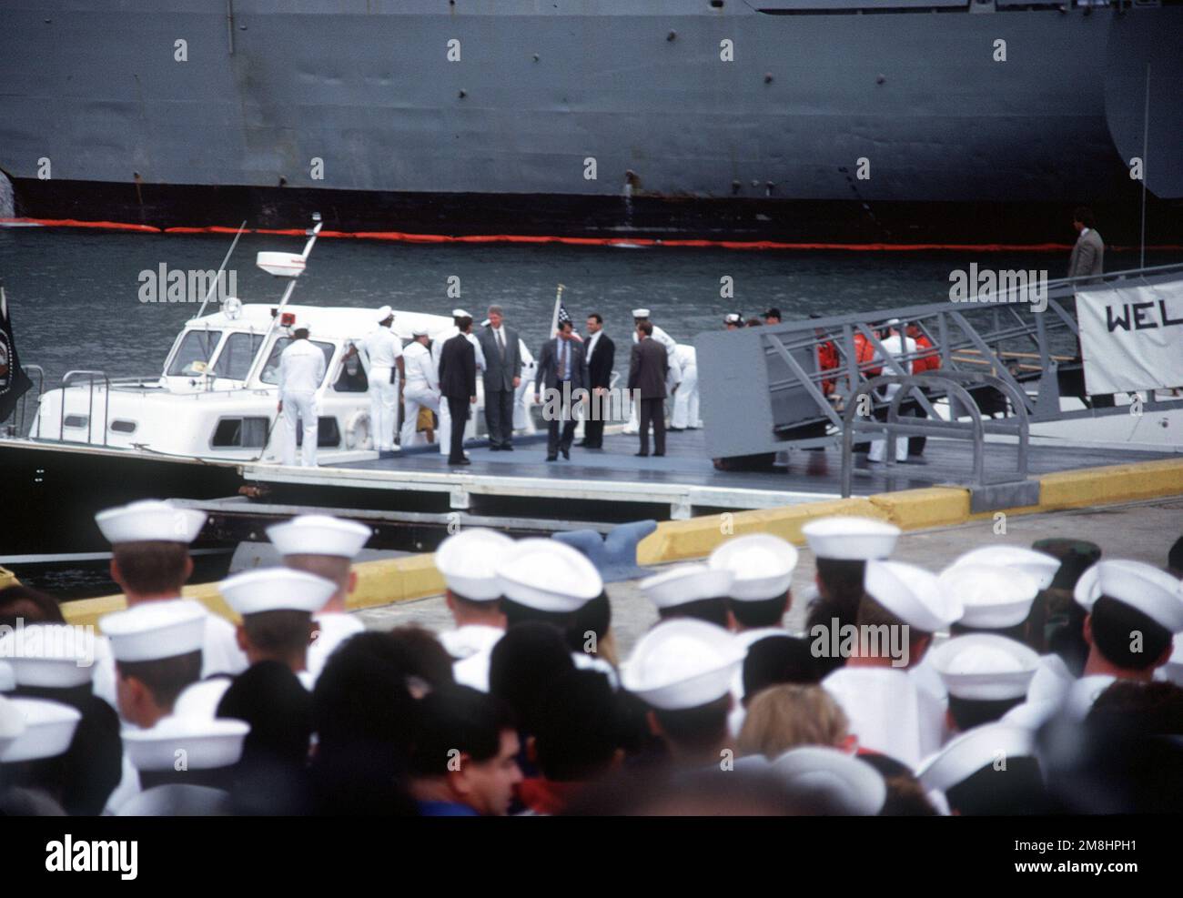 President William Jefferson Clinton and his party disembark from an admiral's barge during his visit to the air station. Clinton is at the air station to address sailors and civilians on base closure issues. The president will also visit sailors on the nuclear-powered aircraft carrier USS CARL VINSON (CVN-70) and the nuclear-powered guided missile cruiser USS ARKANSAS (CGN-41). Base: Naval Air Station, Alameda State: California (CA) Country: United States Of America (USA) Stock Photo