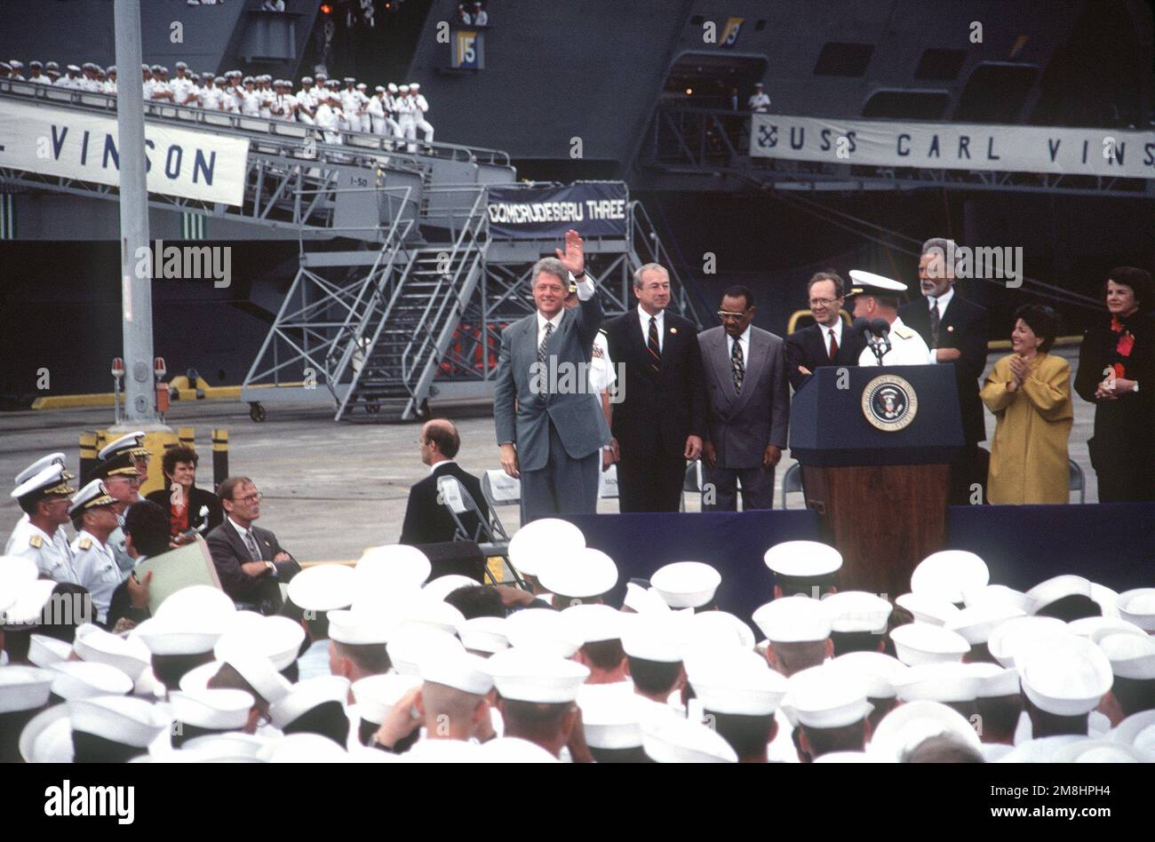 President William Jefferson Clinton waves to the audience after addressing sailors and civilians on base closure issues during his visit to the air station. Clinton will also visit to the air station. Clinton will also visit sailors on the nuclear-powered aircraft carrier USS CARL VINSON (CVN 70) and the nuclear-powered guided missile cruiser USS ARKANSAS (CGN 41). Base: Naval Air Station, Alameda State: California (CA) Country: United States Of America (USA) Stock Photo