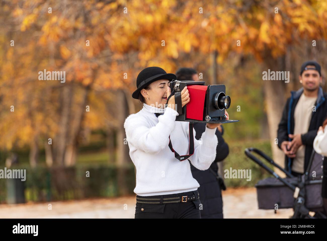 Female artistic photographer with a fake vintage bellows camera (Canon) in  the Buen Retiro Park (Parque del Buen Retiro). Madrid, Spain, Europe Stock  Photo - Alamy