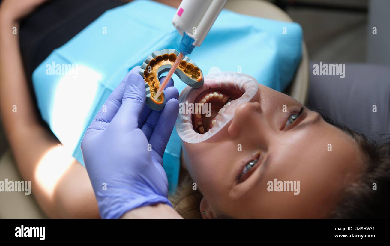 Orthodontist works with shape of jaw cast in process of prosthetics of