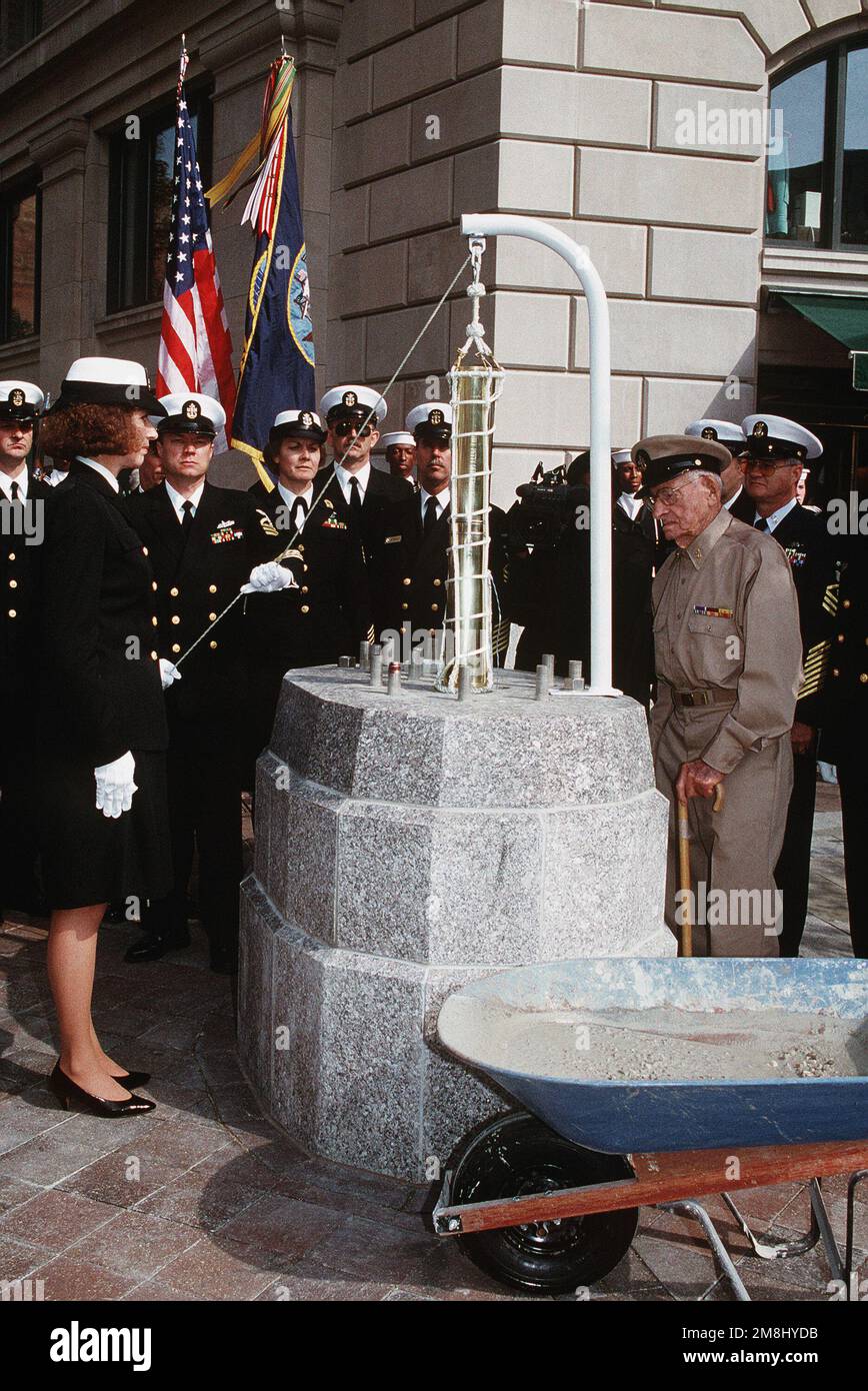 As part of the Navy's 218th Birthday celebration, a time capsule commemorating the 100th anniversary of the establishment of the chief petty officer rank was sealed at the Navy Memorial. Helping to seal the capsule is retired CHIEF Boatswain Mate (BMC) Elridge McWhorter, 91, who served in the Navy from 1919 to 1945. CHIEF Hull Maintenance Technician (HTC) Mike Blanchard lowers the capsule, containing such items as an original CPO cap device, uniform devices worn by current chiefs and a roster of all chief petty officers currently on active duty. Base: Washington State: District Of Columbia (DC Stock Photo
