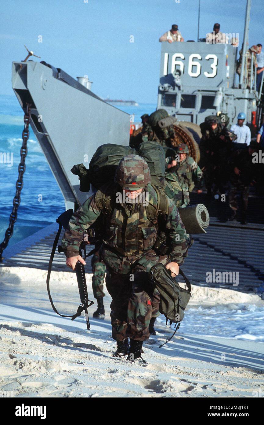 A member of the US Navy Seabees Amphibious Construction Battalion 2, Norfolk, Virginia, armed with an M16 rifle, arrives on shore from a utility landing craft (LCU 1663) on a beach in Egypt during Exercise BRIGHT STAR '94. Subject Operation/Series: BRIGHT STAR '94 Country: Egypt (EGY) Stock Photo