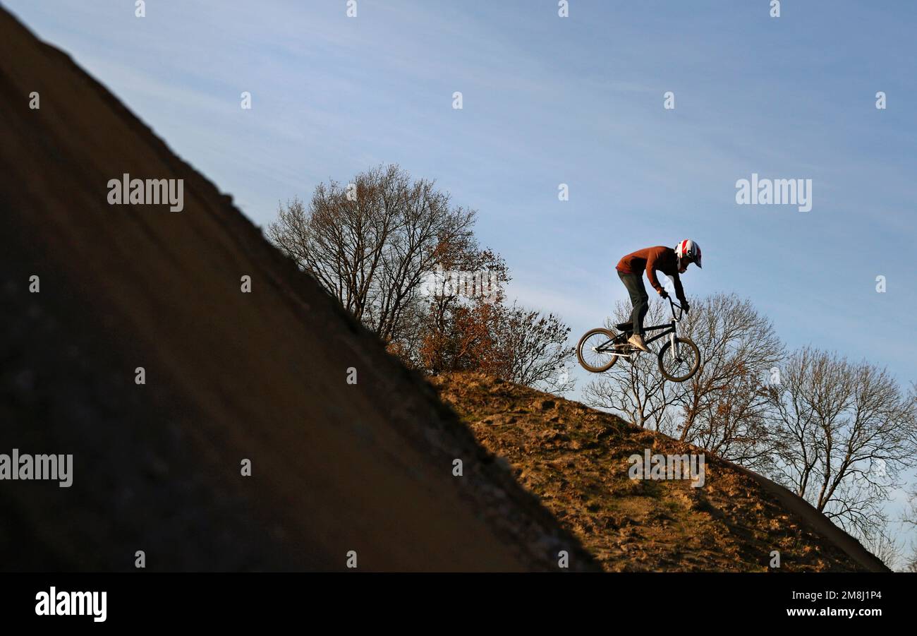 BMX and mountain bike riders in action at Fleet BMX and pump track in Fleet, Hampshire in