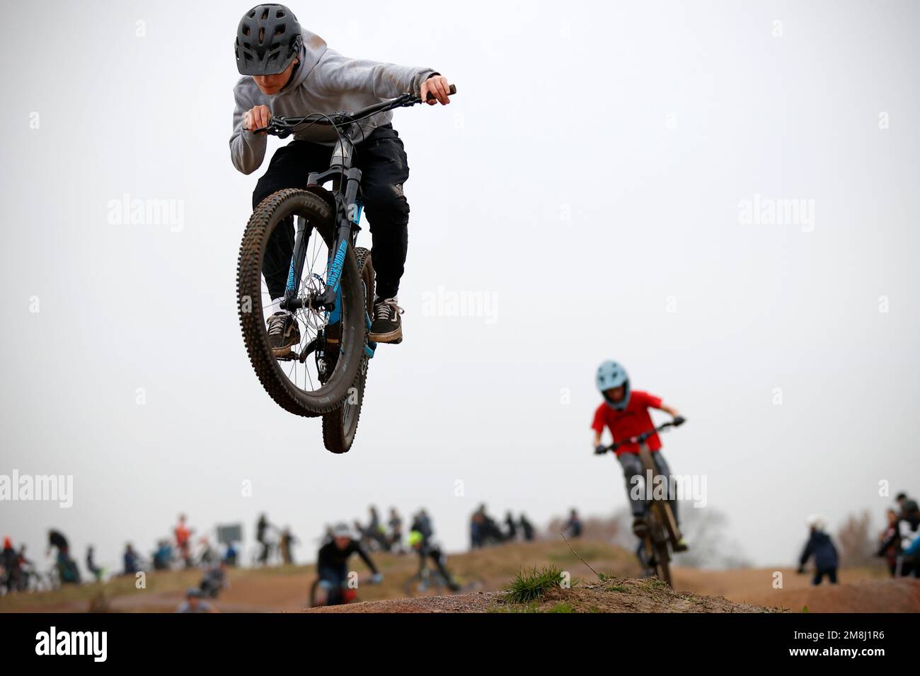BMX and mountain bike riders in action at Fleet BMX and pump track in Fleet, Hampshire in