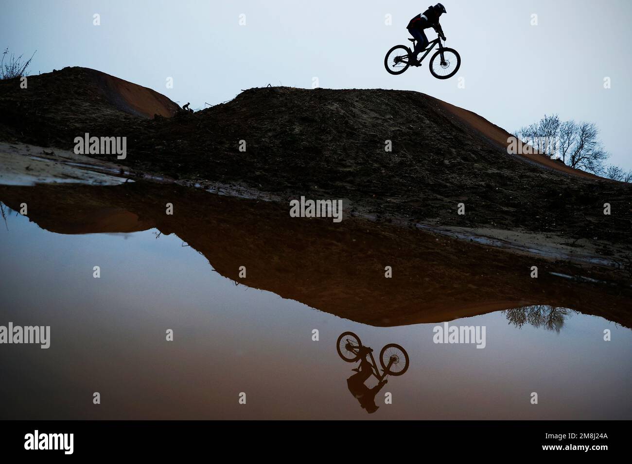 BMX and mountain bike riders in action at Fleet BMX and pump track in Fleet, Hampshire in