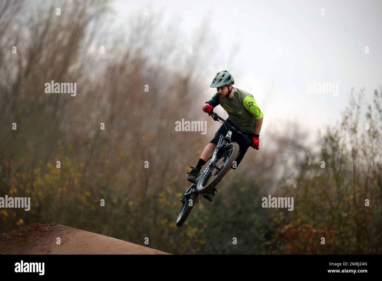 BMX and mountain bike riders in action at Fleet BMX and pump track in Fleet, Hampshire in