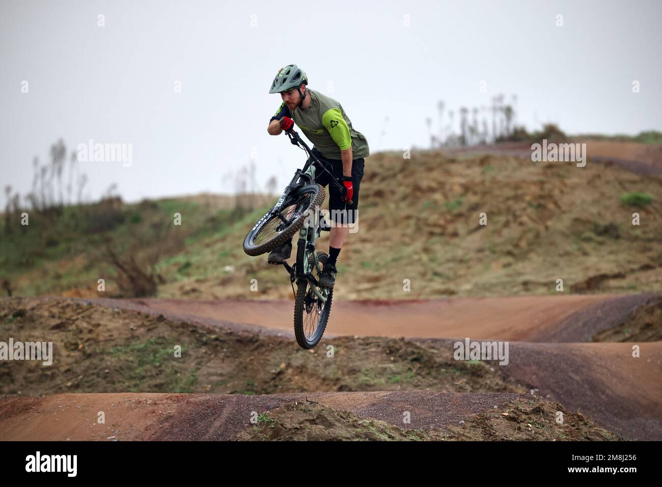 BMX and mountain bike riders in action at Fleet BMX and pump track in Fleet, Hampshire in