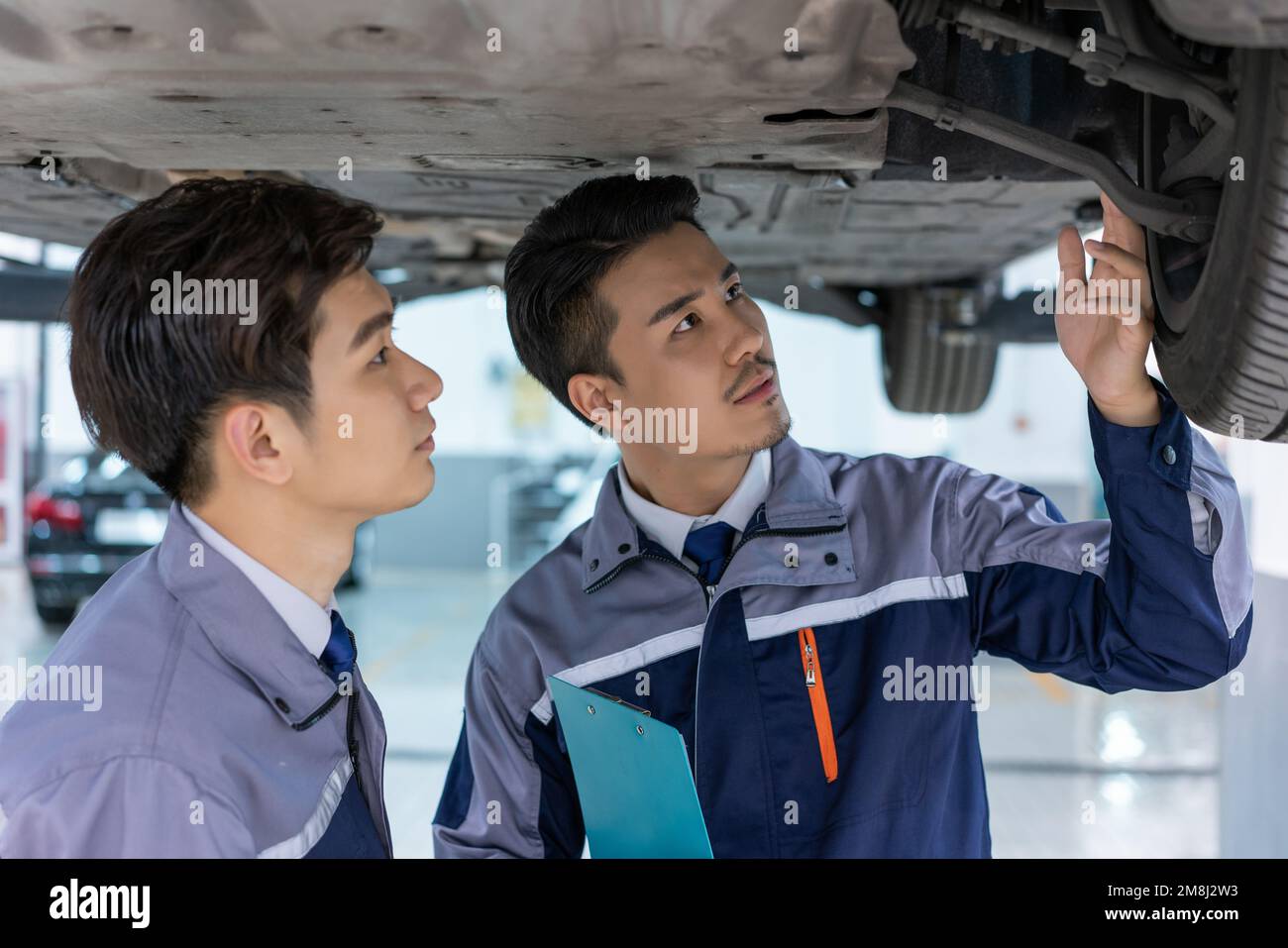 Two engineers auto repair hi-res stock photography and images - Alamy