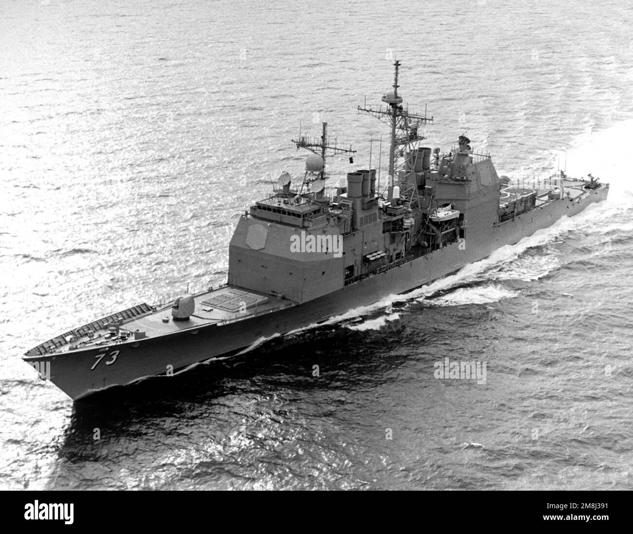 A high oblique port bow view of the guided missile cruiser USS PORT ...