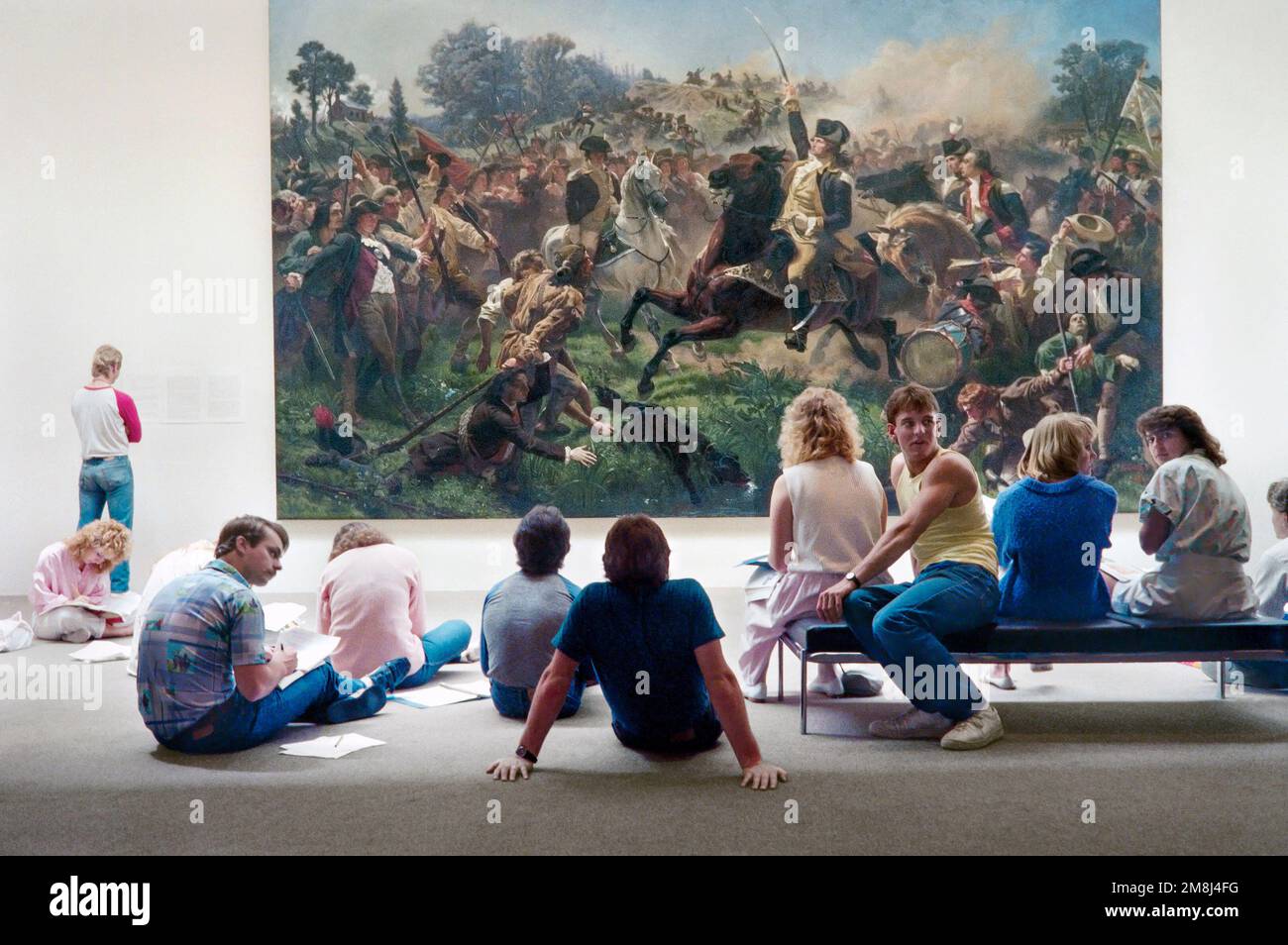 University of California, Berkeley students studying the 1853 painting of Washington Rallying the Troops at Monmouth by Emanuel Leutze. It has been st Stock Photo