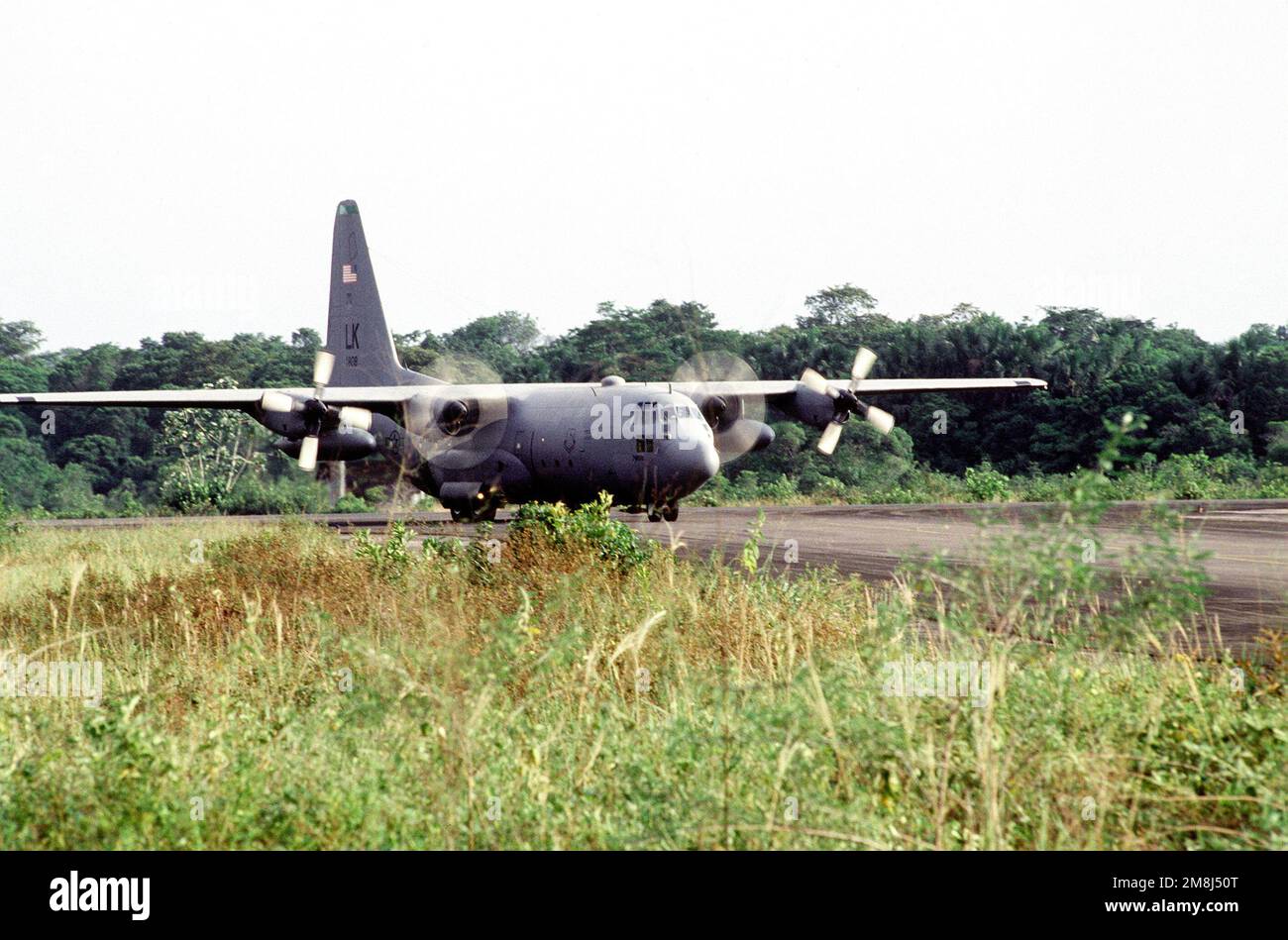 A C-130 Hercules of the 61st Airlift Squadron, Little Rock Air Force Base, Ark., taxis on the flightline of the Johan Adolf Penger Airport carrying supplies and personnel.(Exact date unknown). Subject Operation/Series: DISTANT HAVEN Country: Suriname (SUR) Stock Photo