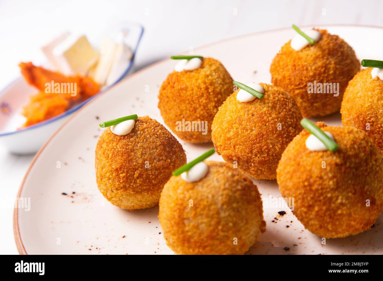 Sobrasada and brie croquettes. Portion of dough made from a dense sauce ...