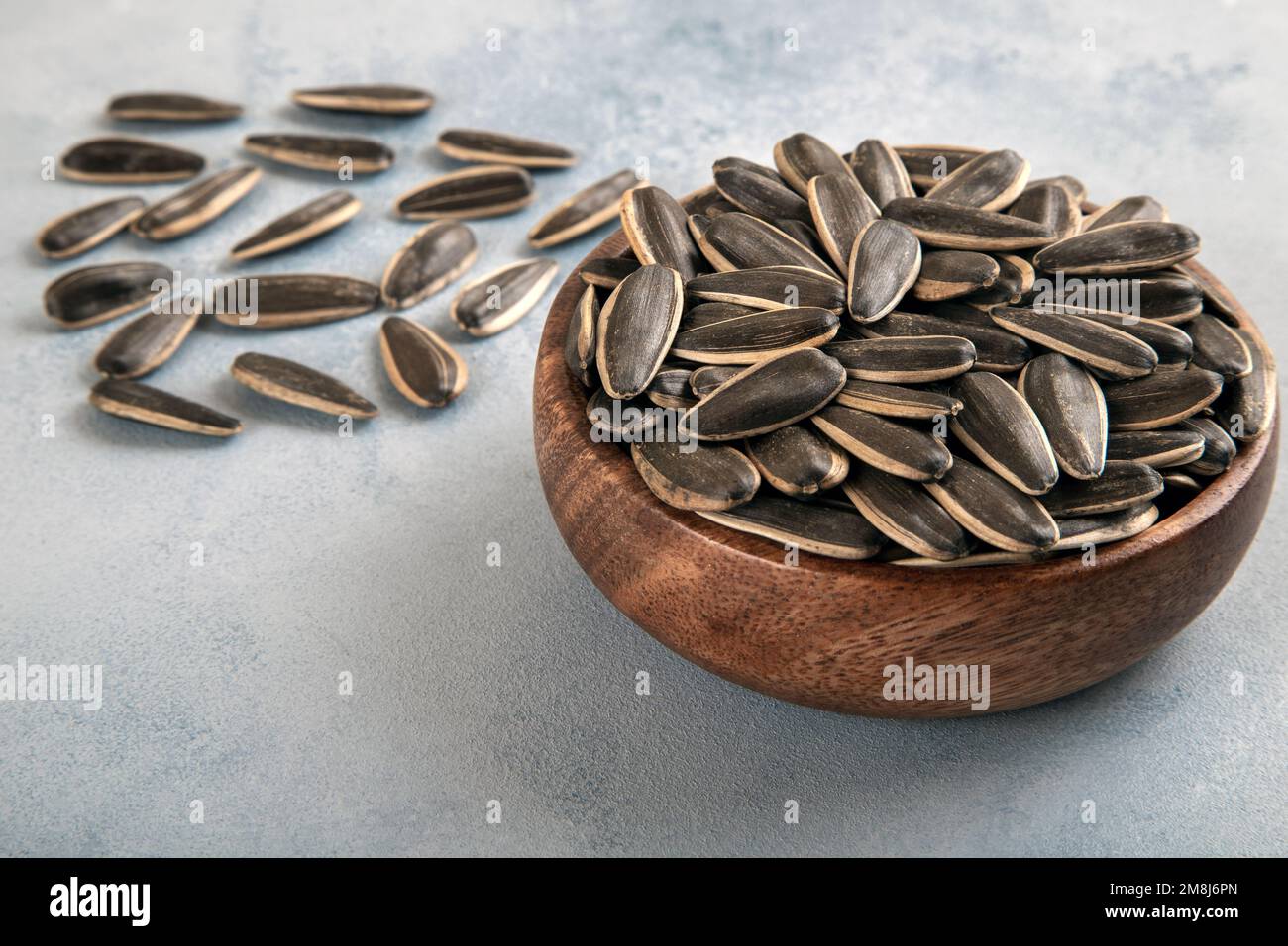 Black sunflower seeds in a bowl,closeup Stock Photo