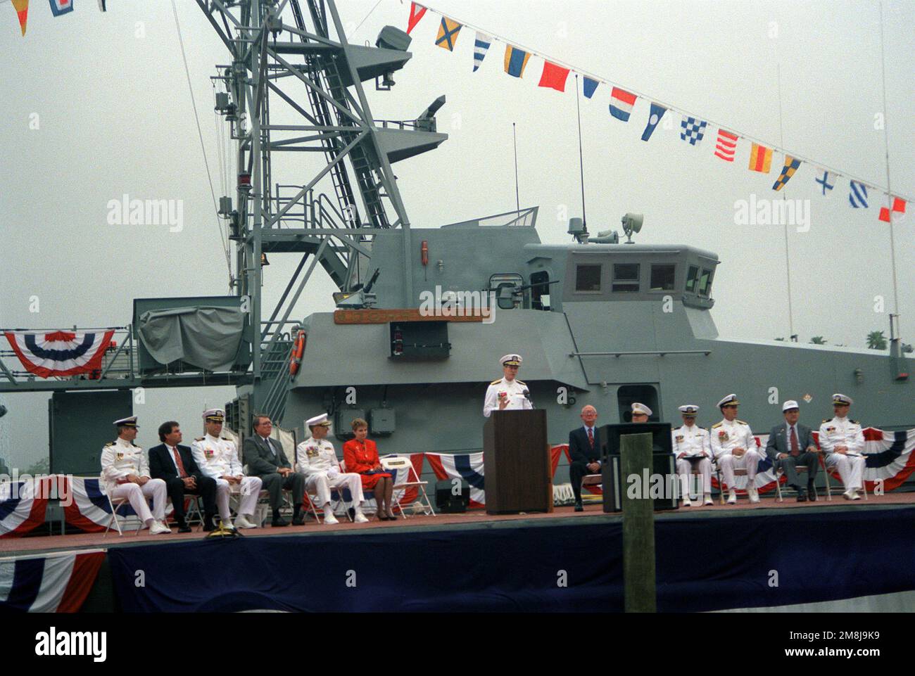 Unidentified guests and officials are shown on the reviewing stand pier ...