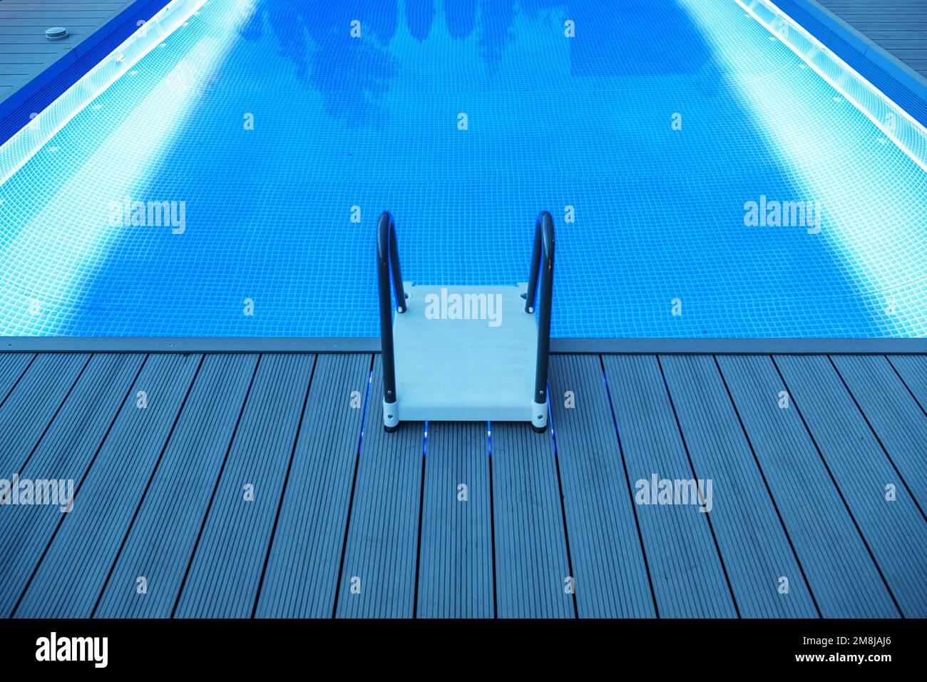 Blue LED Lighting Illuminated Outdoor Residential Pool with a Plastic
