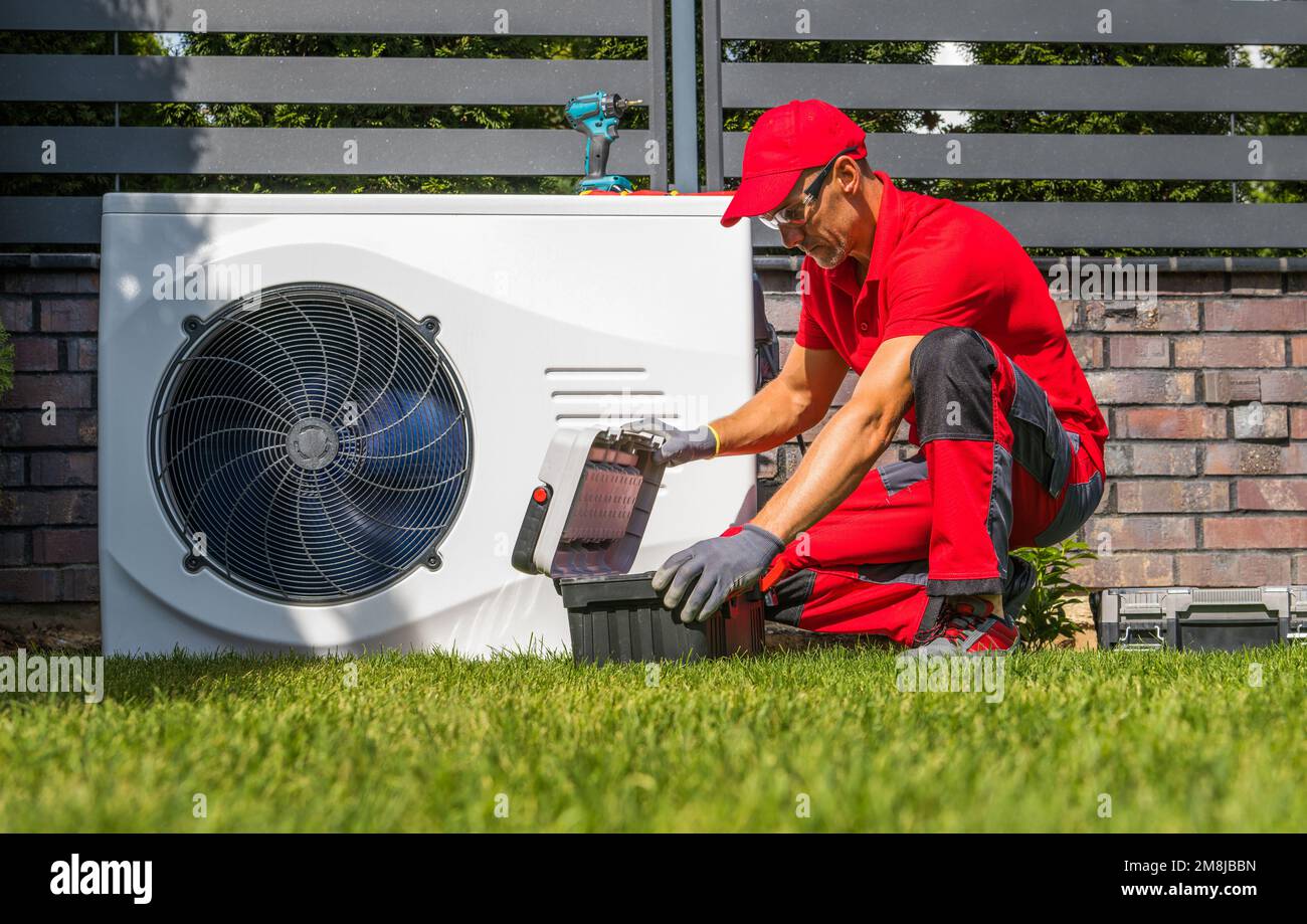 Professional Caucasian Heat Pumps Technician in His 40s Installing New