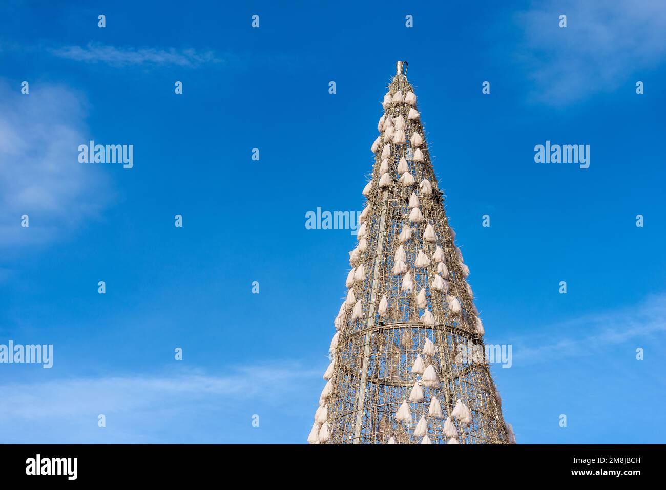 Closeup of a Christmas Tree (high section, photography) against a clear blue sky with copy space. Plaza Mayor (main square), Madrid downtown, Spain. Stock Photo