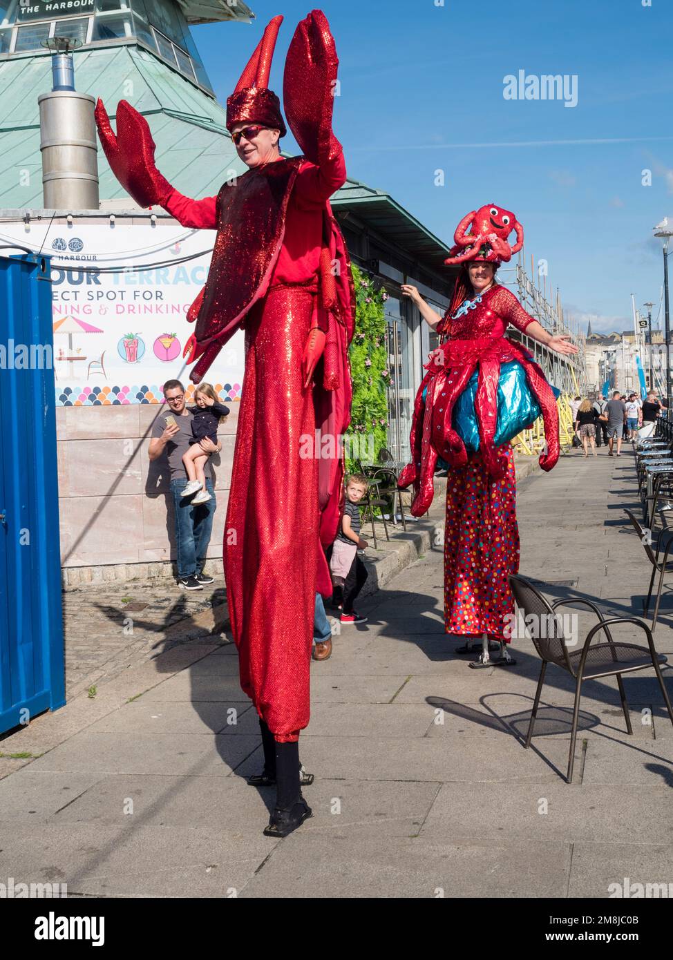 Stilt walkers dressed as lobster and octopus at Plymouth Seafood