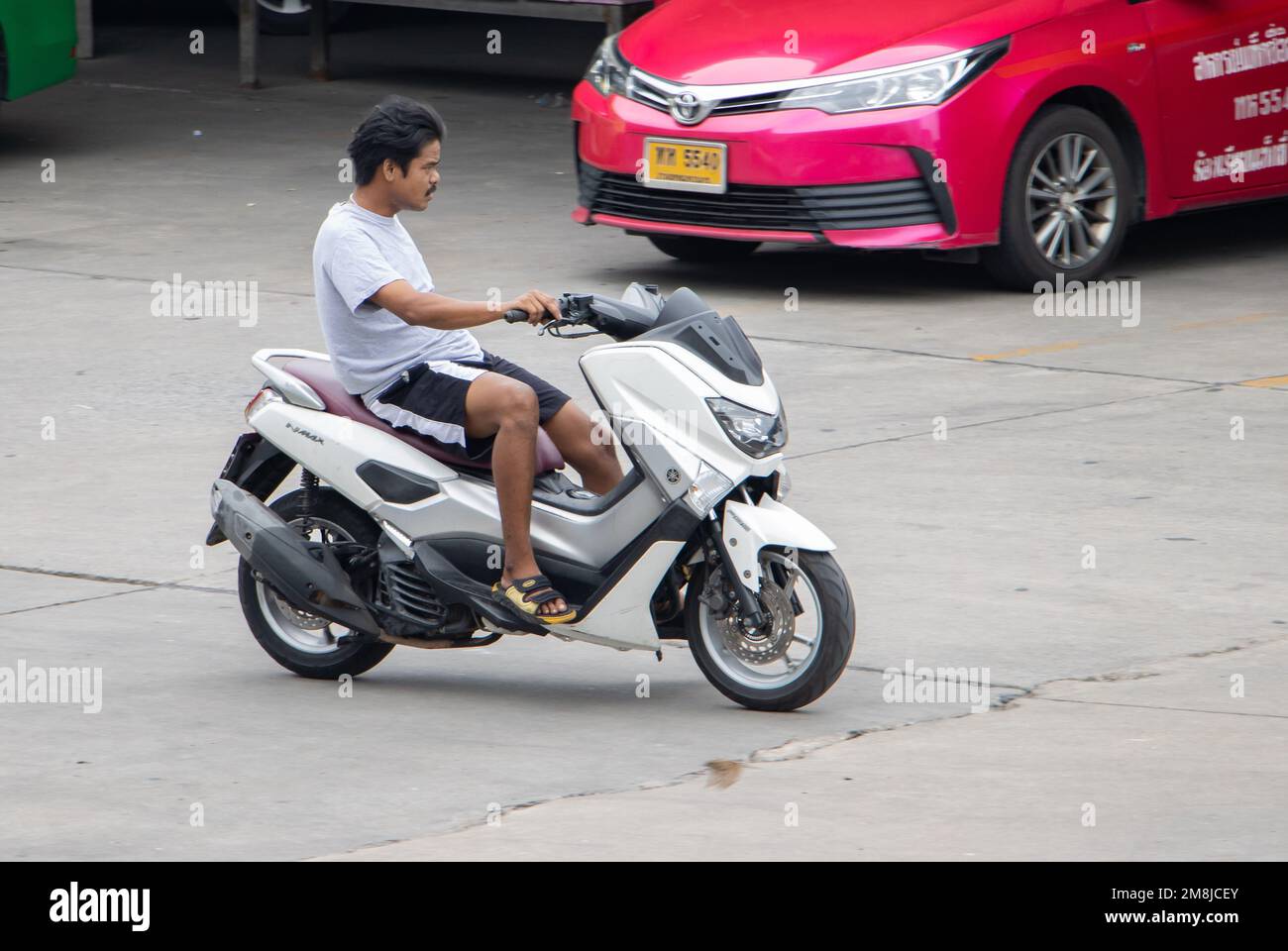 SAMUT PRAKAN, THAILAND, FEB 23 2022, a man riding a motorcycle controlled with one hand Stock Photo