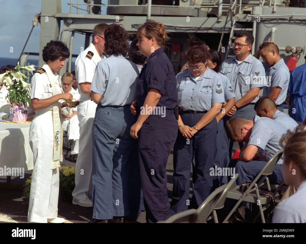 Members of the crew of the submarine tender USS HOLLARD (AS-32) receive ...