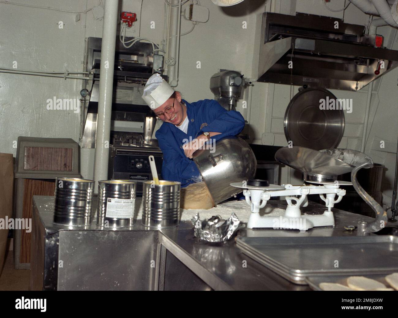 Mess SPECIALIST SEAMAN (MSSN) Erika Wood works in the bakery on board the submarine tender USS HOLLAND (AS-32) preparing bread. Country: Pacific Ocean (POC) Stock Photo