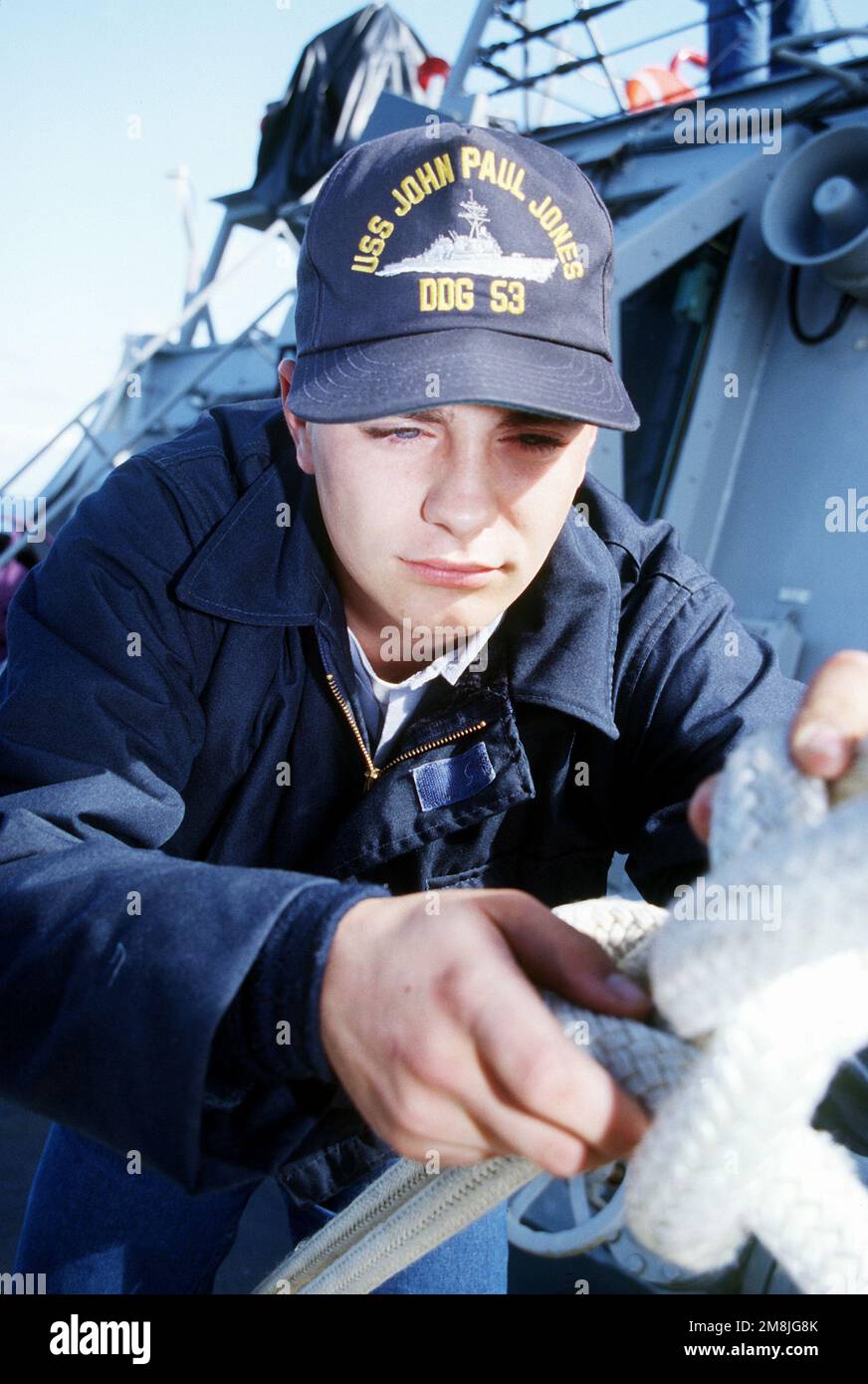 SEAMAN (SN) Eric Humble secures a tiedown line on board the guided