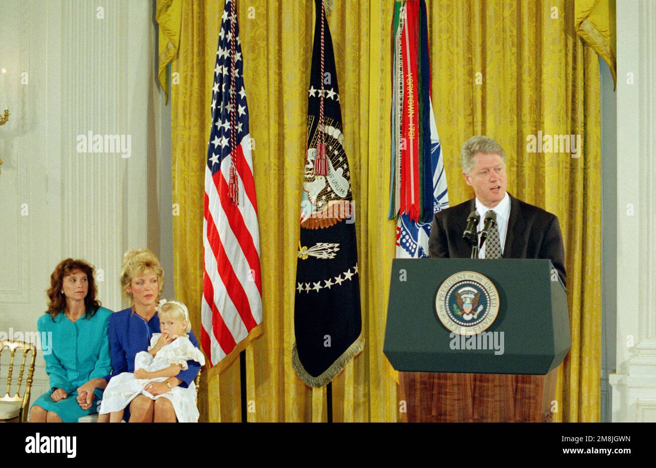 The President of the United States, William J. Clinton presented the nation's highest award for military valor The Medal of Honor (Posthumously) to the widows of Sergeant First Class Randall D. Shughart, Stephanie (left) and MASTER Sergeant Gary I. Gordon, Carmen, with 3-year old Brittany. The Sergeants were killed on 03 October 1993, while serving as Sniper Team Member and Leader, United States Army Special Operation Command with Task Force Ranger in Mogadishu, Somalia. They provided precision sniper fires from the lead helicopter during an assault on a building and at two helicopter crash si Stock Photo