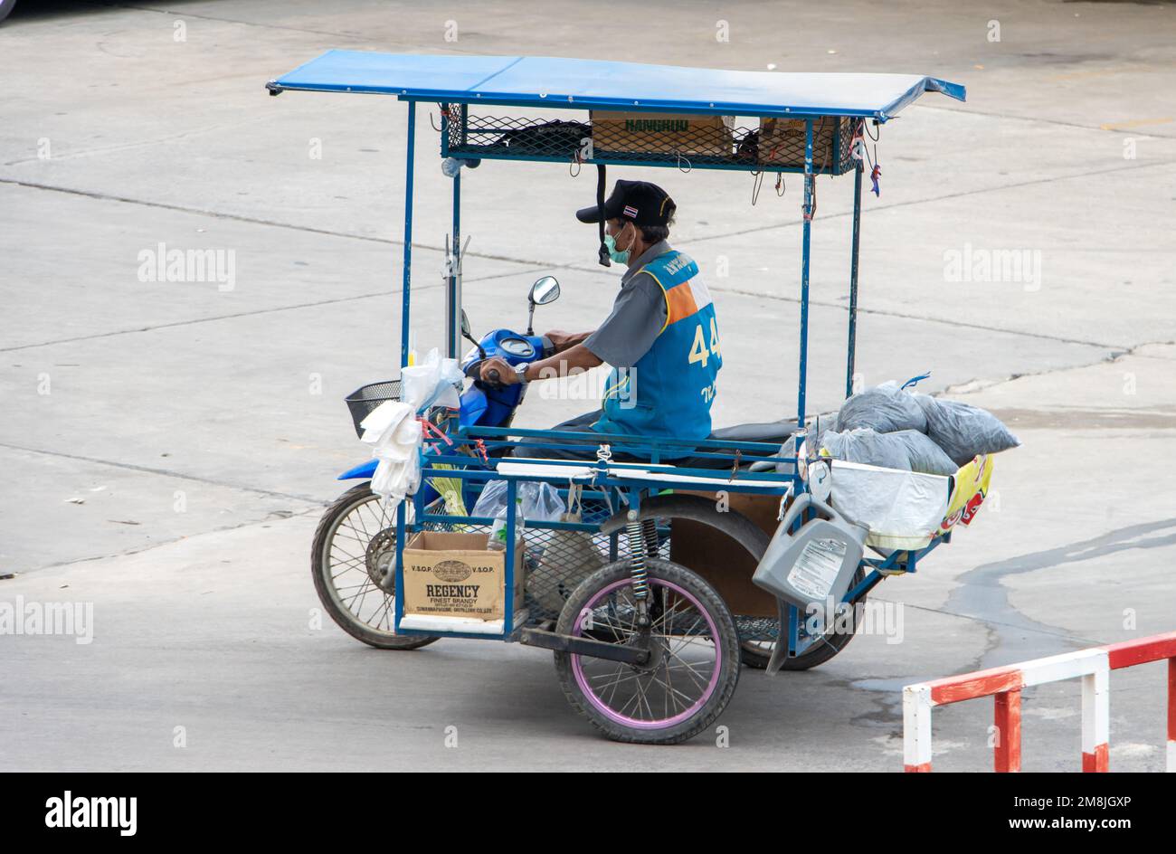 SAMUT PRAKAN, THAILAND, MARCH 02 2022, Mototaxi driver with a sidecar ride on the street Stock Photo