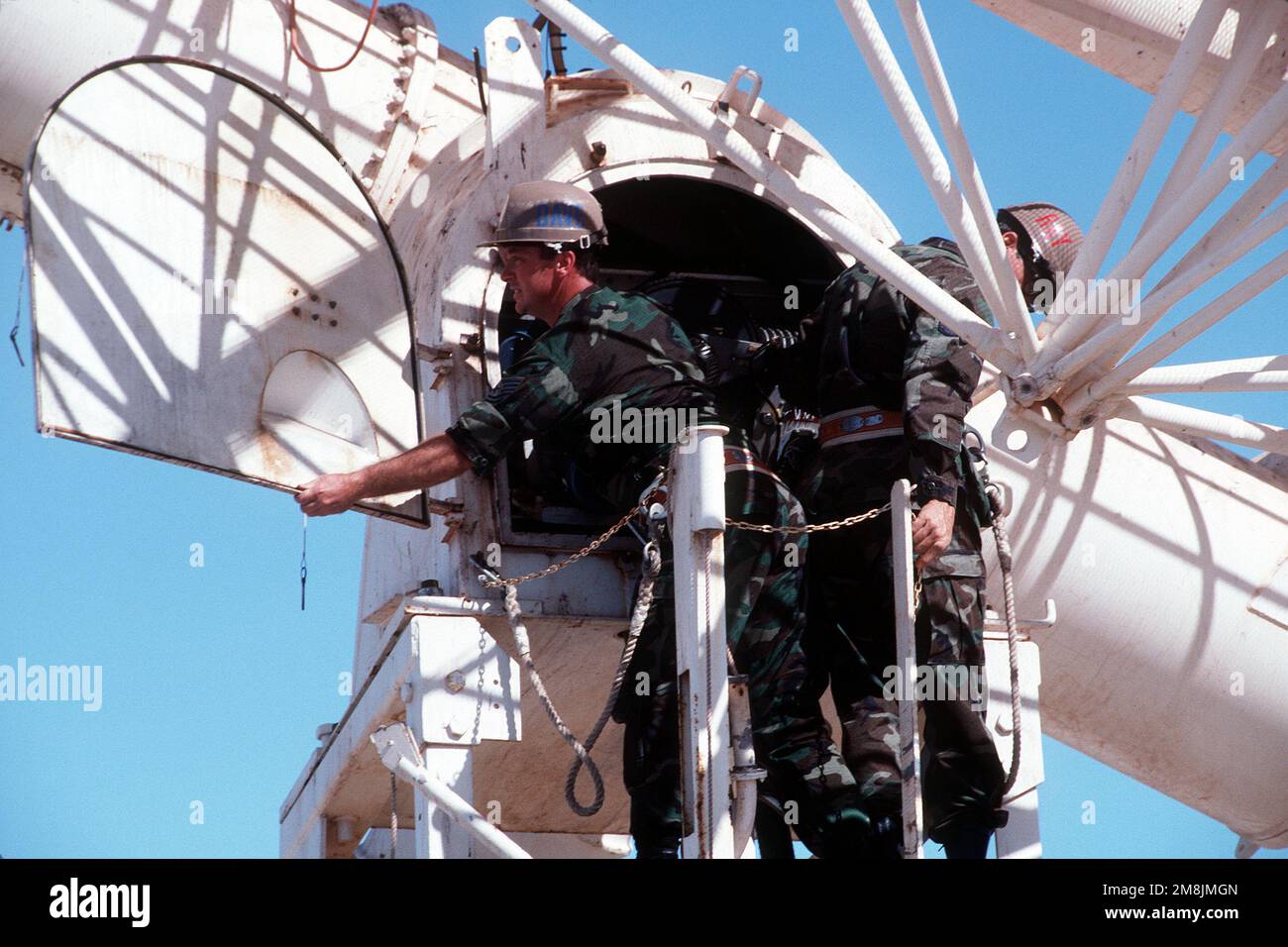TECH. SGT. Dave Stapchuck and MASTER SGT. Ray Coffman check the 28-foot-diameter radio telescope. The two are assigned to Detachment 1, 50th Weather Squadron at Learmonth, Australia, which, along with six other Air Weather Service solar observatories around the globe, monitors solar activities 24 hours a day. Exact Date Shot Unknown .Published in AIRMAN Magazine November 1994. Base: Learmouth Country: Australia (AUS) Stock Photo