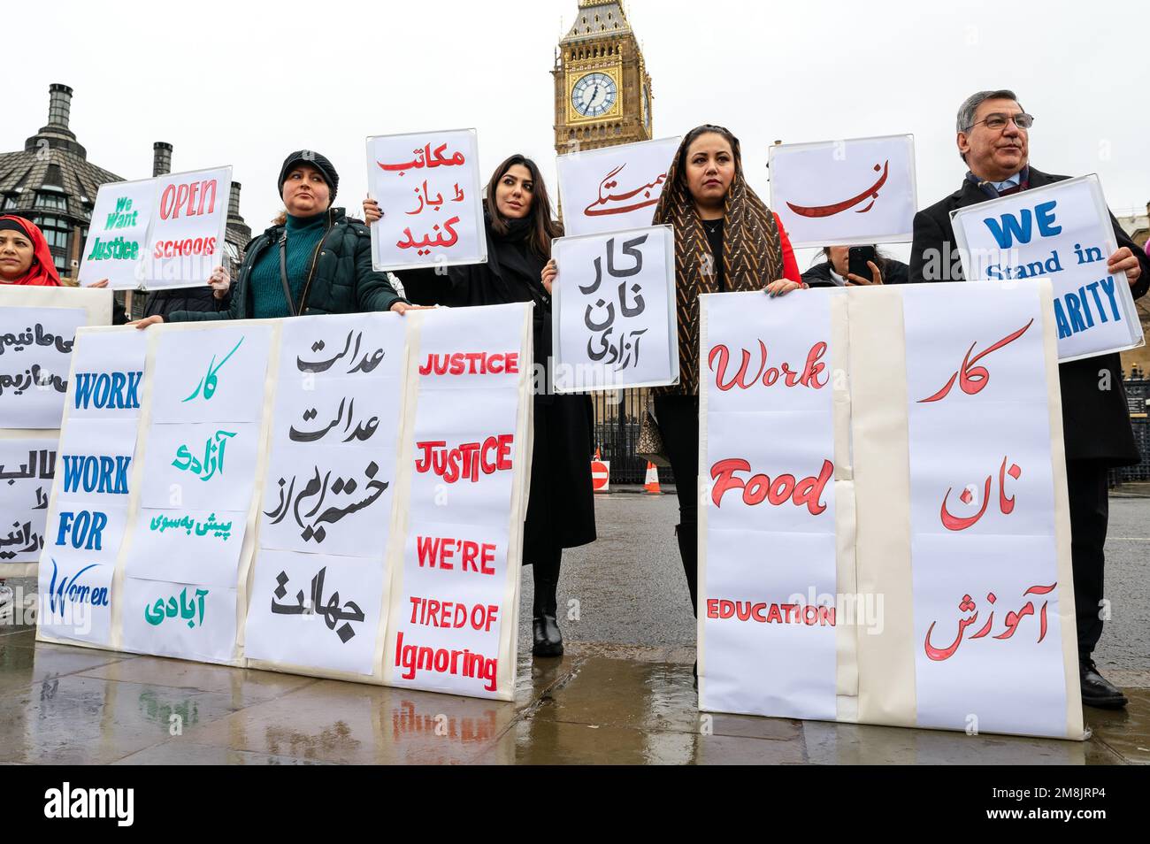 London, UK. 14 January 2023. Protest for Afghan women and girls for freedom to work, food and education. Protesters hold placards in Parliament Square. Credit: Andrea Domeniconi/Alamy Live News Stock Photo