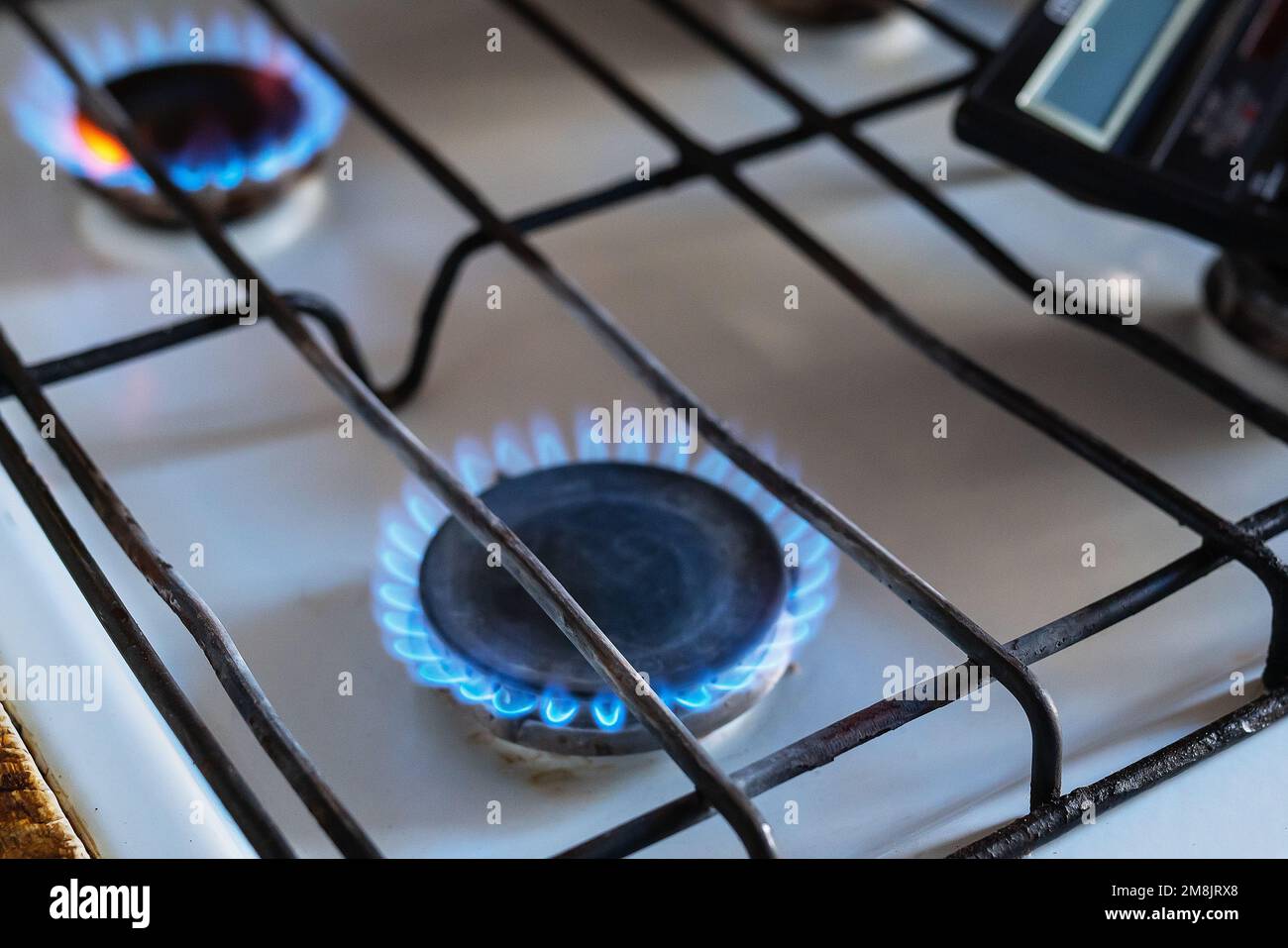Gas is burning in the burner of the kitchen stove. Energy crisis. High cost, the price of gas