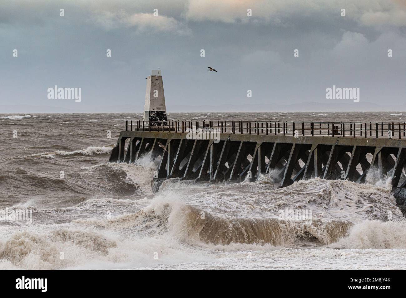 Maryport, UK.14 January 2023. High winds and waves batter the coastline of Cumbria near to the seaside town of Maryport in Cumbria. Credit: Julian Elliott/Alamy Live News Stock Photo