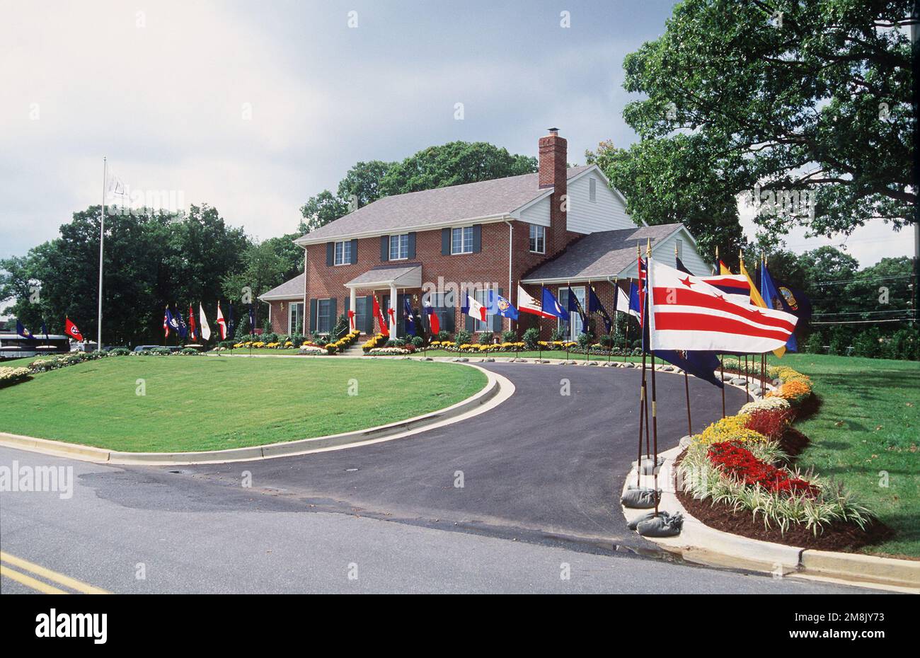 A front view of the new Fisher House dressed with flags and flowers for
