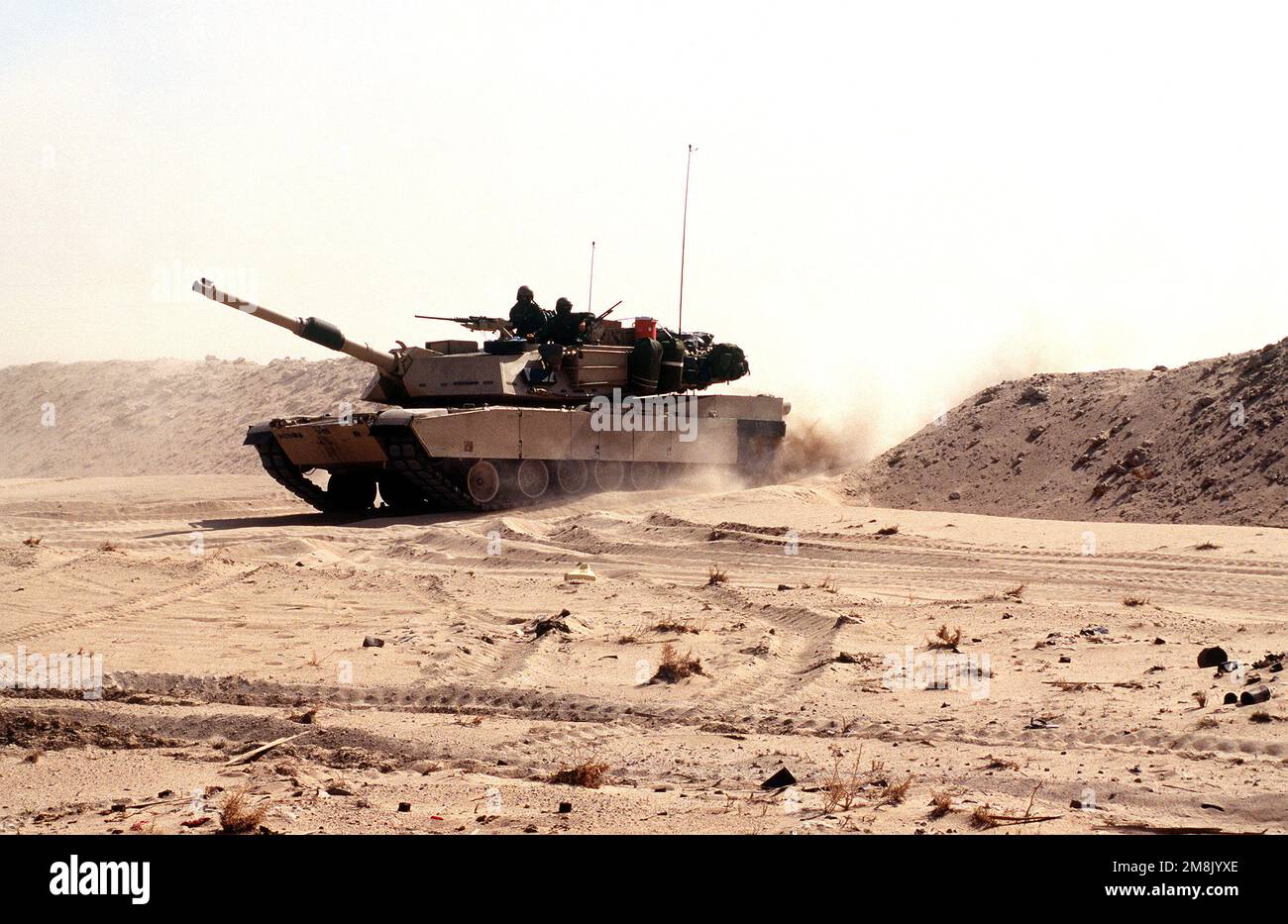 An M1a1 Abrams Tank Breaches A Berm In The Desert During Maneuvers