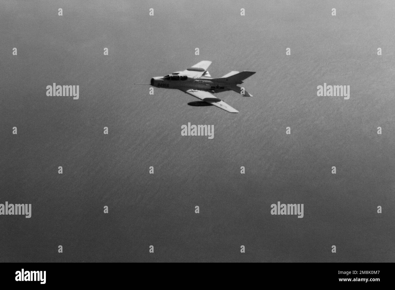 Aerial view of a Peoples Republic of China Liberation Army Air Force FT-6 Farmer-F fighter trainer aircraft in flight. Country: South China Sea Stock Photo