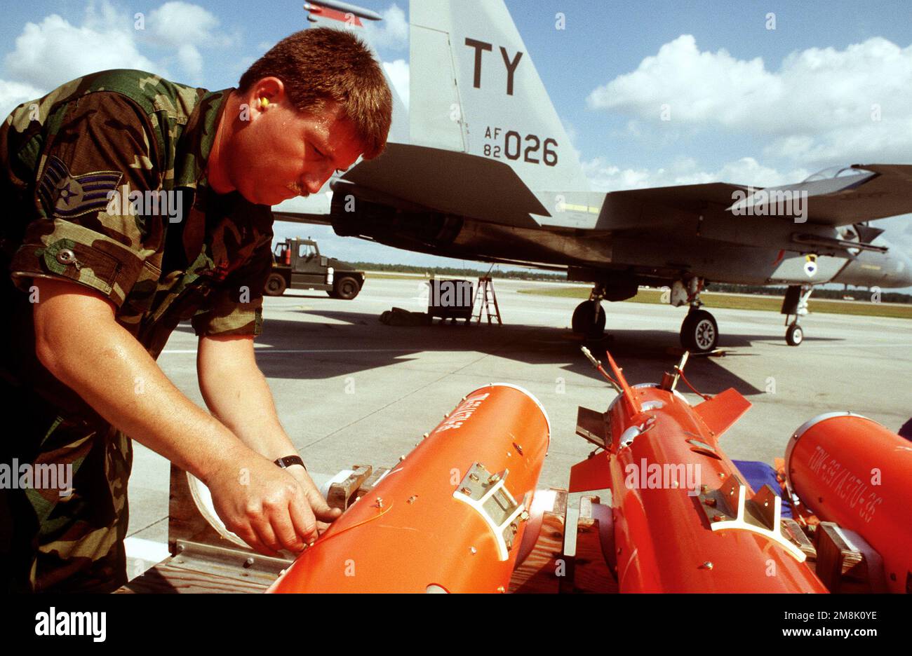 STAFF SGT. James Wilson straps AGTS-36 Aerial GUNNERY Target Sets to a weapons trailer on the flightline during competition William Tell '94. The AGTS-36 is towed behind a specially modified F-15 Fighter aircraft to provide the competing teams something at which to shoot their 20mm lead. ammunition at. Base: Tyndall Air Force Base State: Florida (FL) Country: United States Of America (USA) Stock Photo