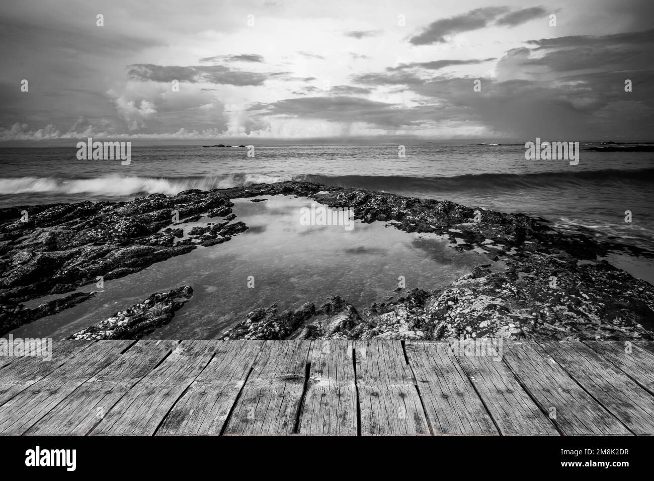 An image of waves crashing with stones in black and white Stock Photo ...