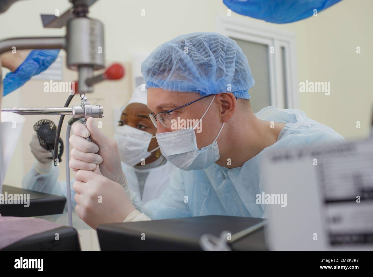 the doctor, together with an assistant, conducts a proctological medical examination of the patient in the treatment room. Stock Photo