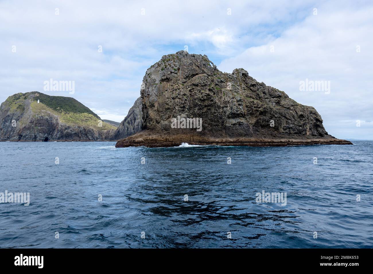A landscape view with of a hole in the rock, Piercy Island, New Zealand