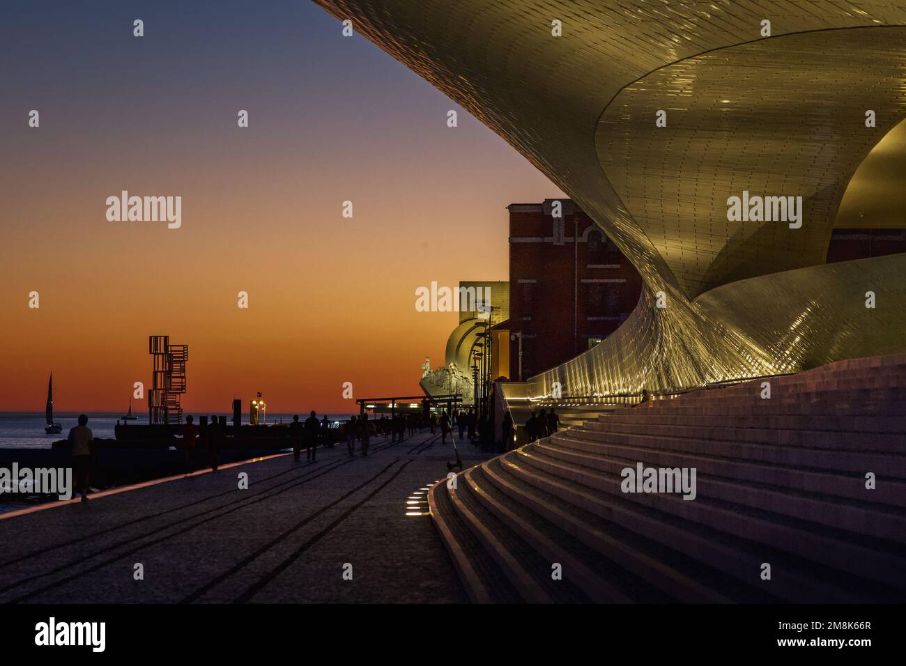 Twilight by the Tagus River, the Museum of Art, Architecture and Technology (MAAT), and the Monument of the Discoveries in Lisbon, Portugal. Stock Photo