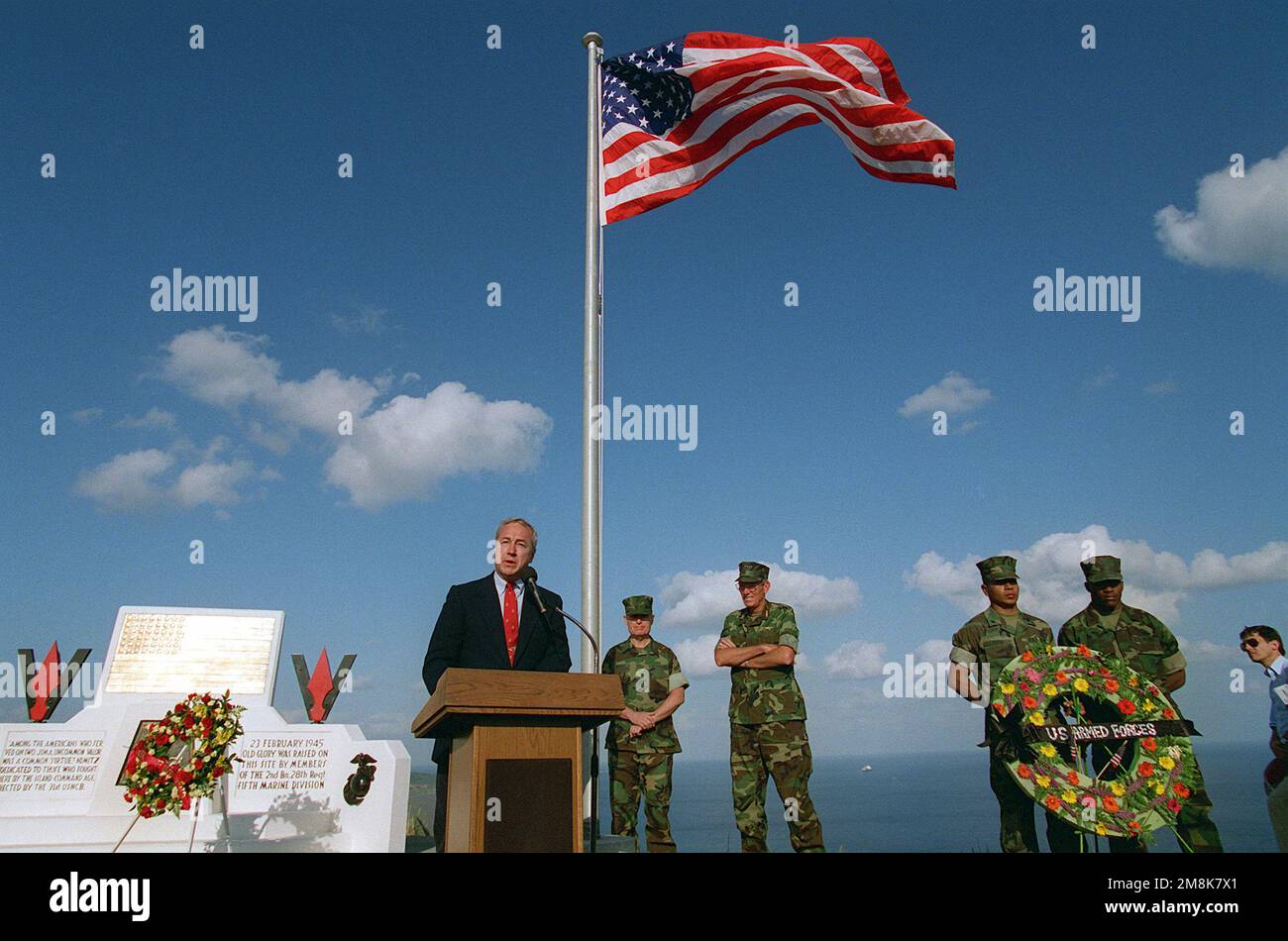 Secretary of the Navy John H. Dalton addresses a large group of active duty military and veterans attending the 50th anniversary memorial ceremony atop Mount Suribachi. He stated 'Honor, courage, commitment as words, they are easy to say. Here on Iwo Jima, they were turned into deeds, deeds that will forever guide the Naval service'. Also present for the ceremony were General Carl E. Mundy, Jr. Commandant of the Marine Corps (rear left) and Admiral Richard C. Macke, Commander-In-CHIEF, U.S. Pacific Command (rear left). Base: Iwo Jima Country: Japan (JPN) Stock Photo